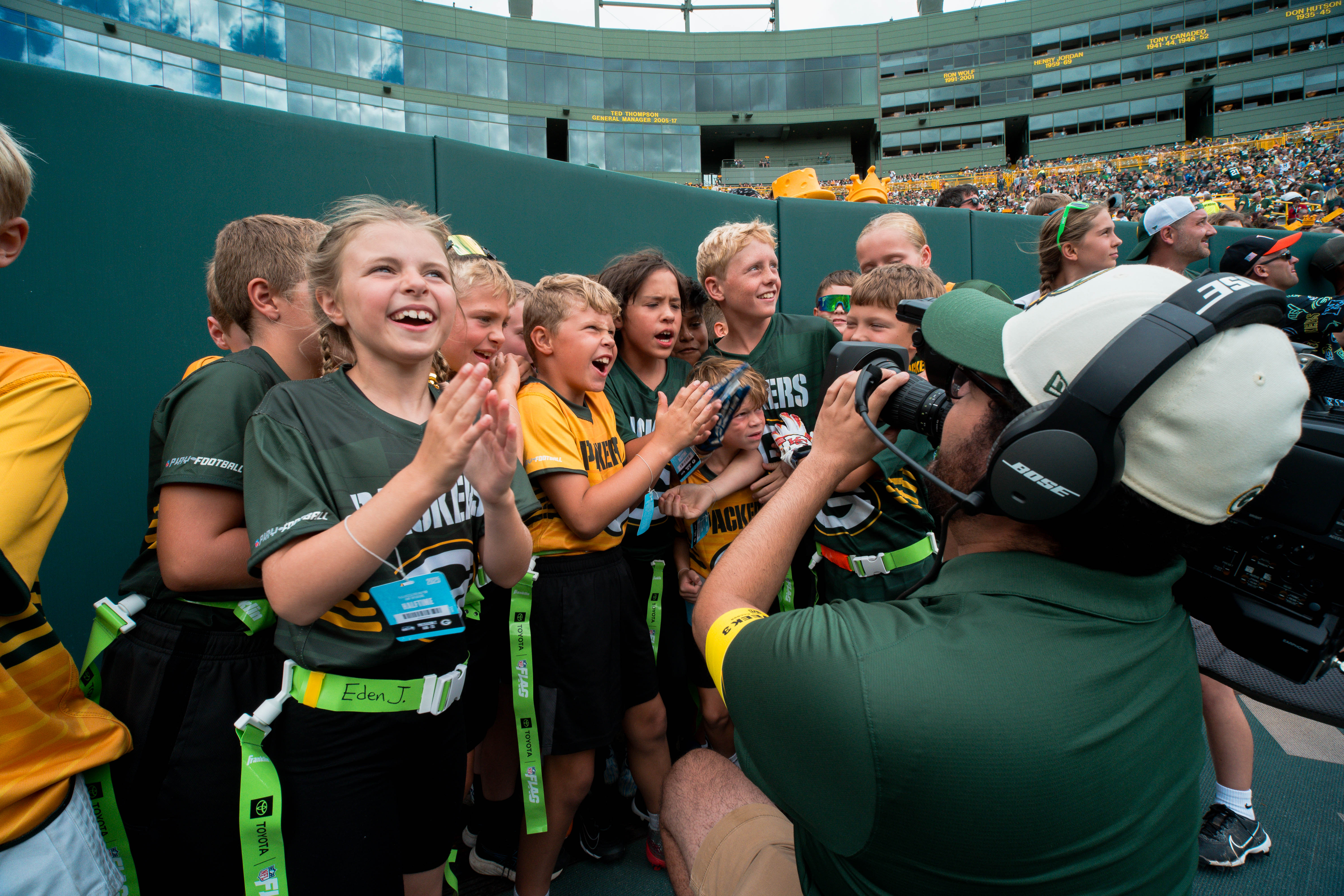 The Verona Area flag football team visits Lambeau Field in Green Bay, Wisconsin, ahead of their halftime game during the NFL preseason matchup between the Green Bay Packers and Seattle Seahawks on August 23, 2025. Photography by Ross Harried for Second Crop Sports.