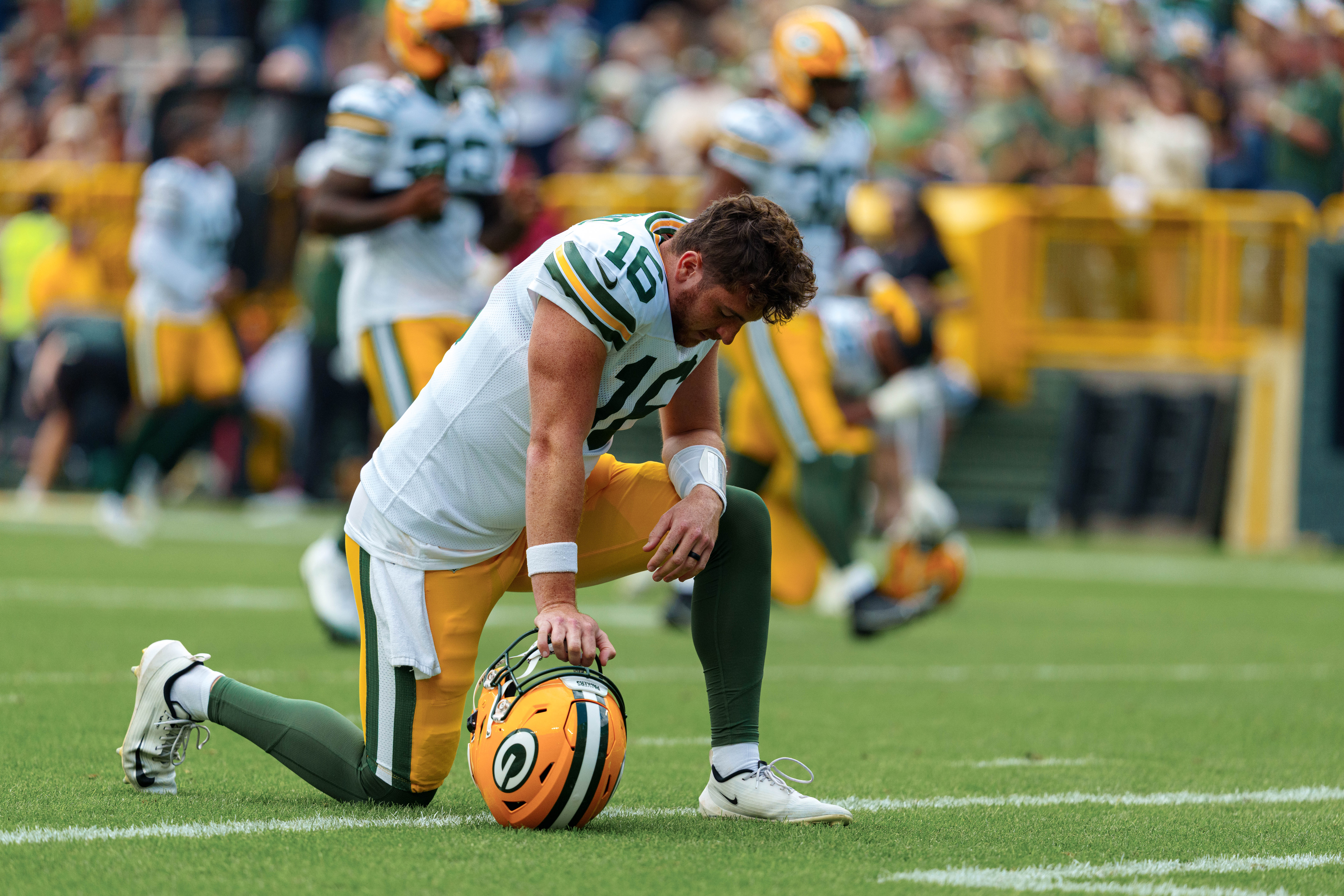 Green Bay Packers quarterback Sean Clifford (16) takes a knee before taking on the Seattle Seahawks at Lambeau Field on August 23, 2025 in Green Bay, Wisconsin. Photography by Ross Harried for Second Crop Sports.