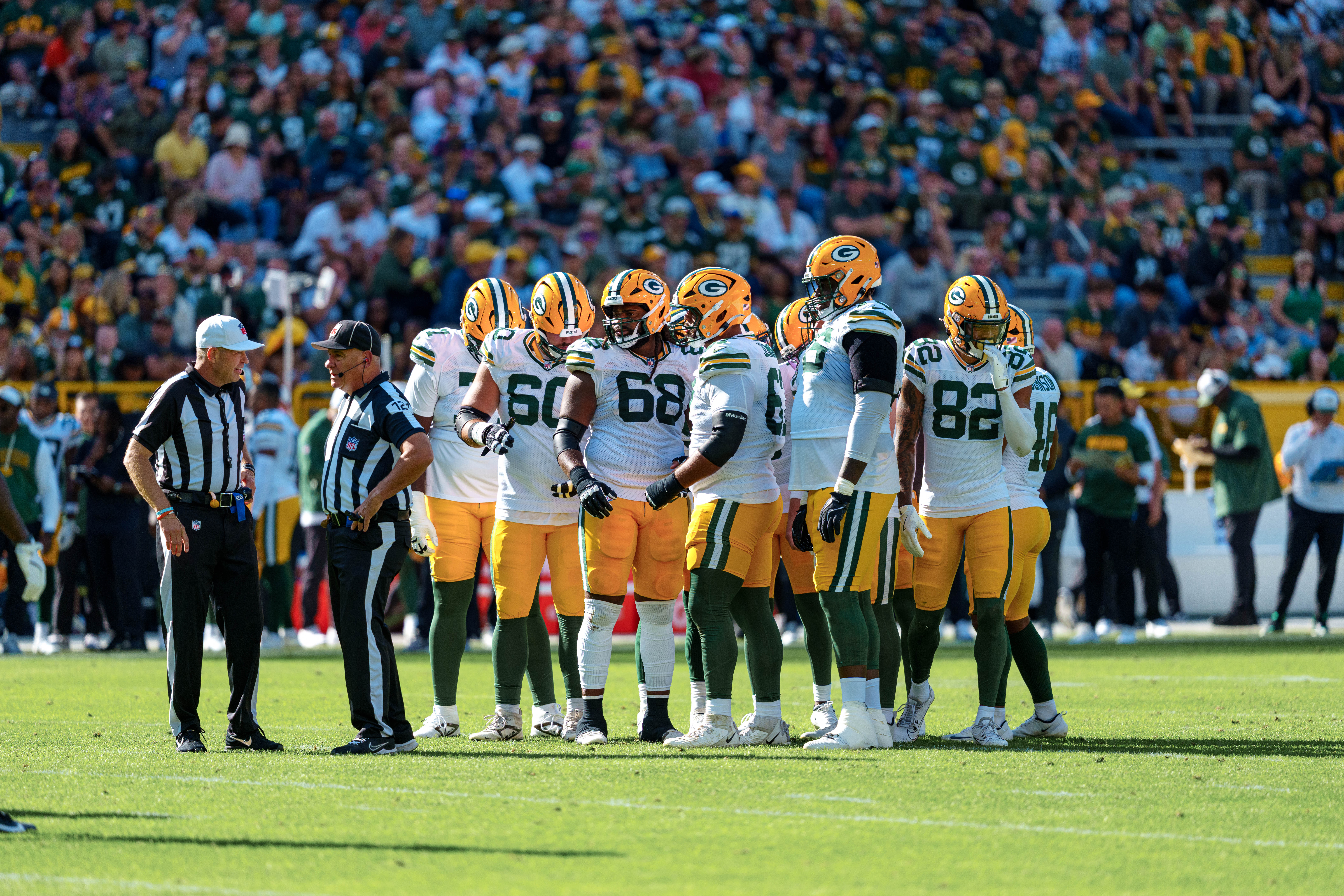 The Green Bay Packers offense huddles up in the second quarter against the Seattle Seahawks at Lambeau Field on August 23, 2025 in Green Bay, Wisconsin. Photography by Ross Harried for Second Crop Sports.