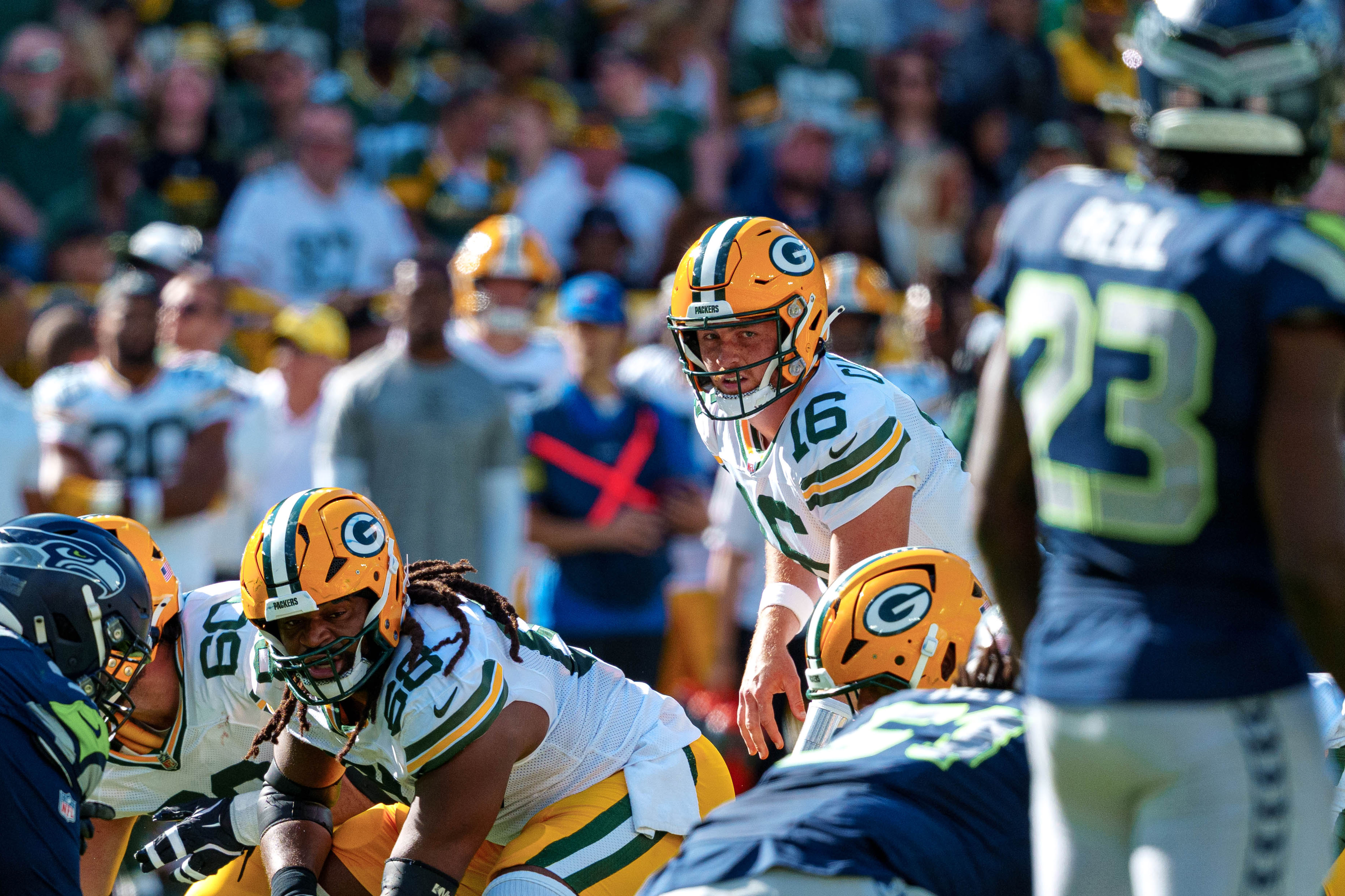 Green Bay Packers quarterback Sean Clifford (16) looks at Seattle Seahawks safety D'Anthony Bell (23) at Lambeau Field on August 23, 2025 in Green Bay, Wisconsin. Photography by Ross Harried for Second Crop Sports.