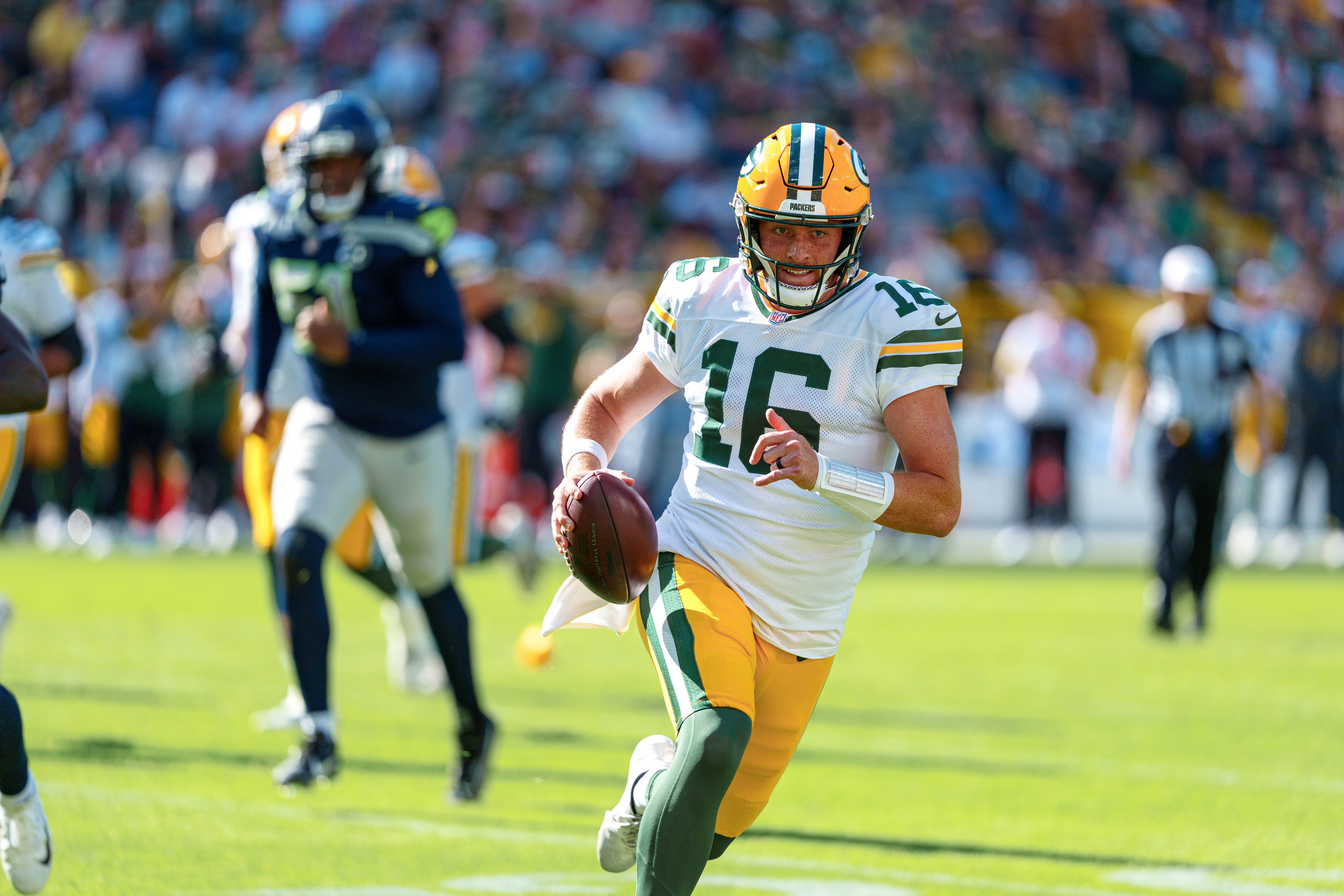 Green Bay Packers quarterback Sean Clifford (16) runs for the sideline against theSeattle Seahawks at Lambeau Field on August 23, 2025 in Green Bay, Wisconsin. Photography by Ross Harried for Second Crop Sports.