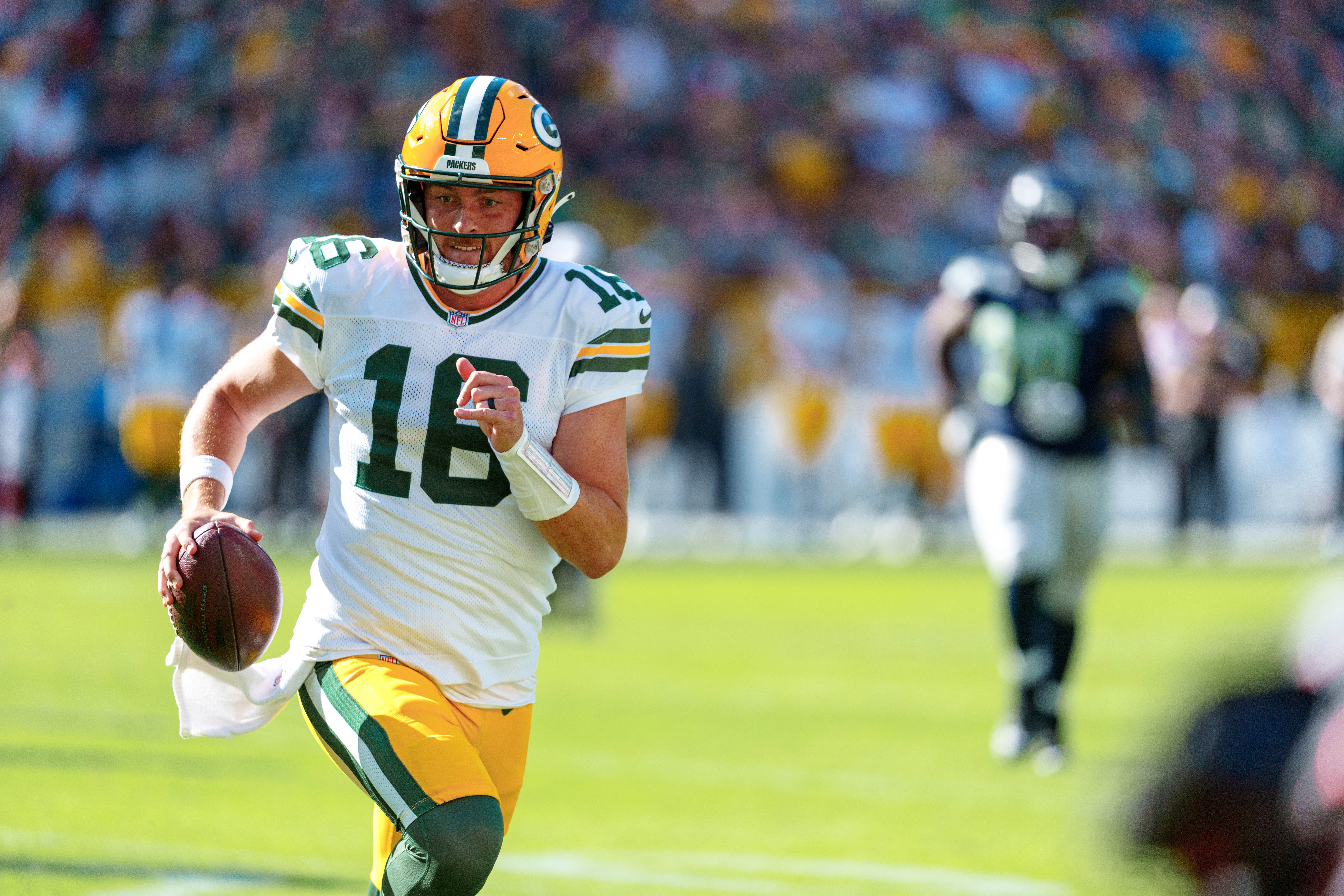 Green Bay Packers quarterback Sean Clifford (16) runs for the sideline against theSeattle Seahawks at Lambeau Field on August 23, 2025 in Green Bay, Wisconsin. Photography by Ross Harried for Second Crop Sports.