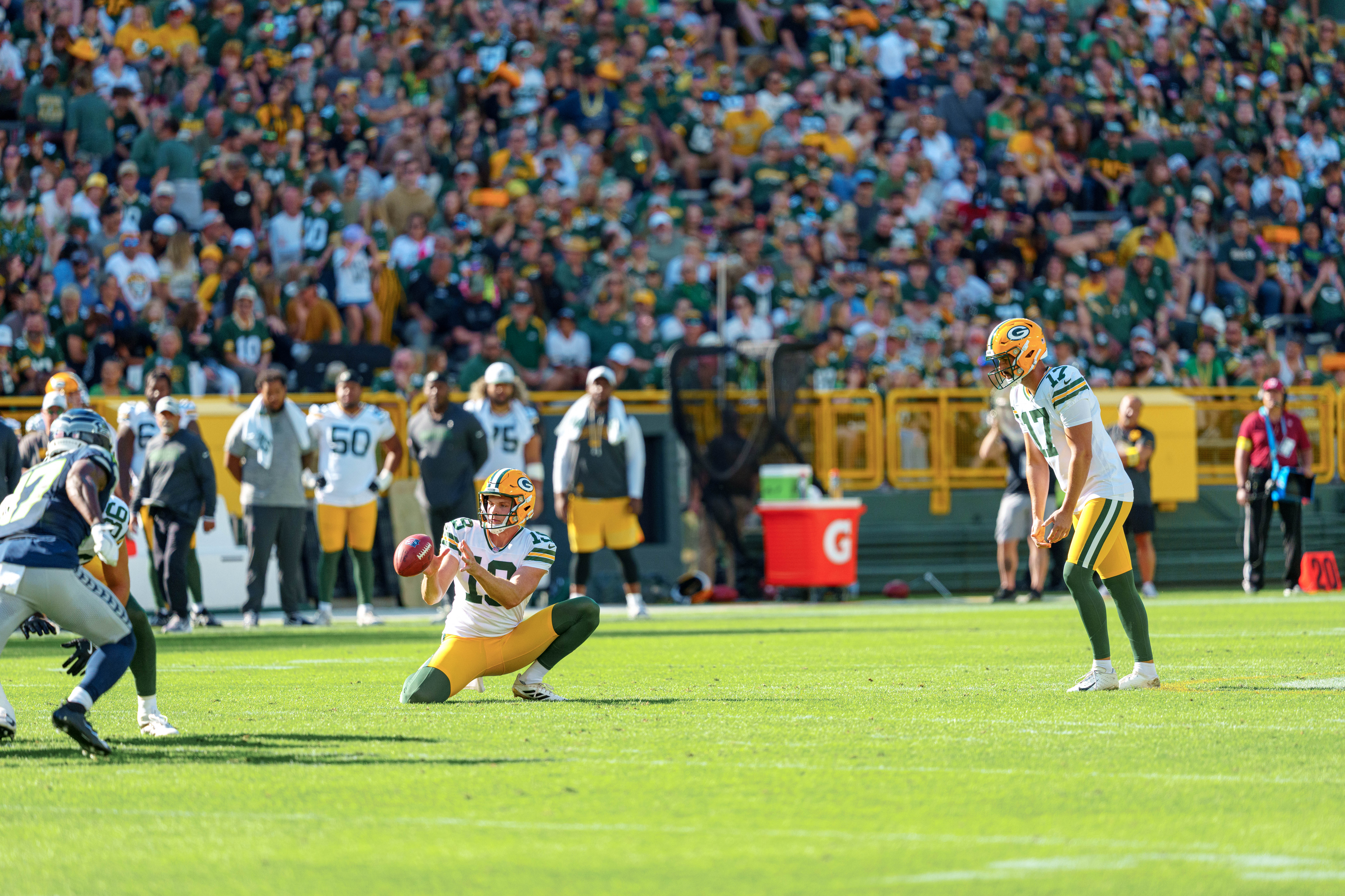 Green Bay Packers quarterback Taylor Elgersma (19) takes a long snap while kicker Brandon McManus (17) gets ready to kick a field goal in the second quarter against the Seattle Seahawks at Lambeau Field on August 23, 2025 in Green Bay, Wisconsin. Photography by Ross Harried for Second Crop Sports.