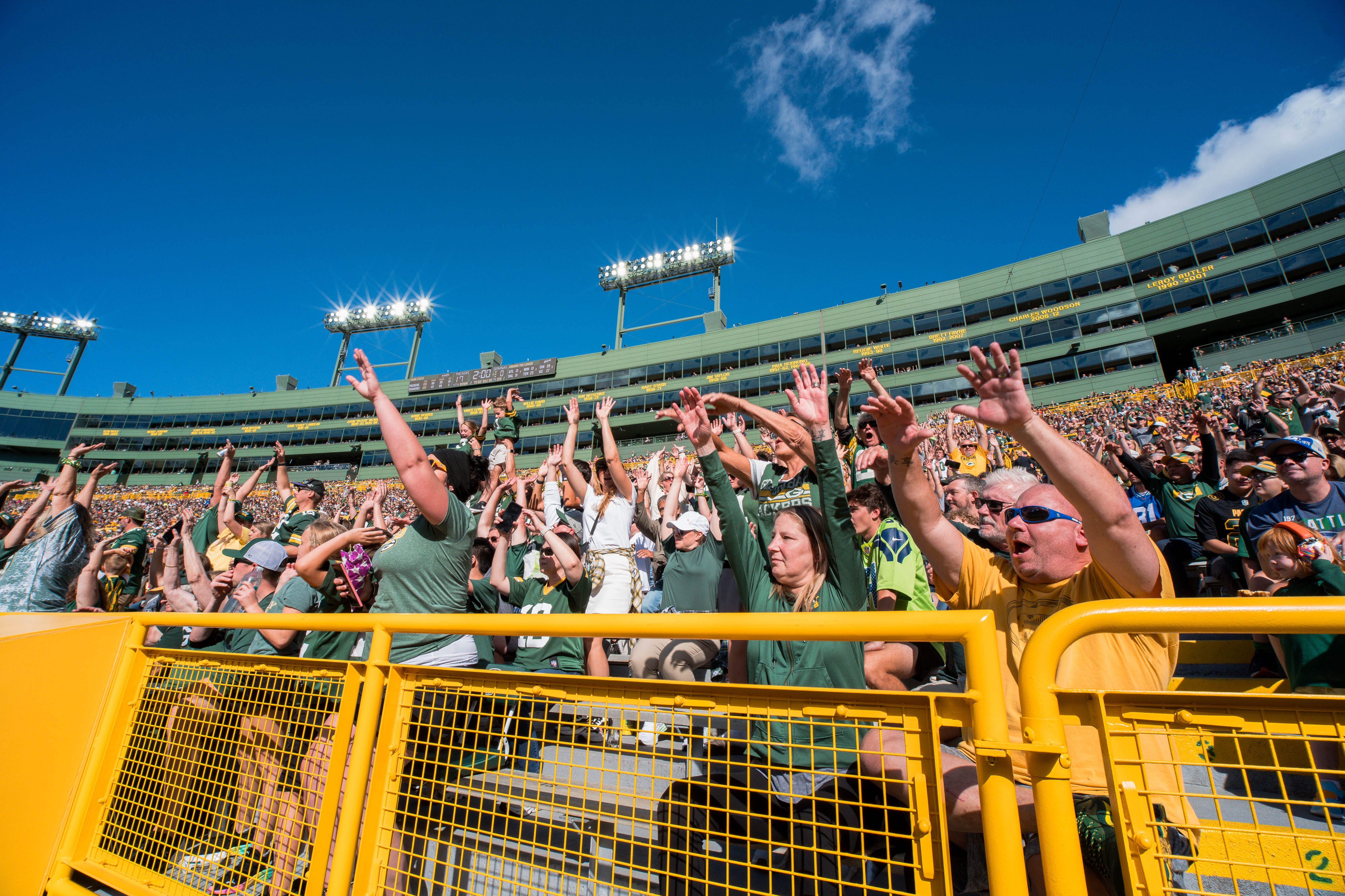 Fans at Lambeau Field do the wave before halftime of the Green Bay Packers vs. Seattle Seahawks game at Lambeau Field on August 23, 2025 in Green Bay, Wisconsin. Photography by Ross Harried for Second Crop Sports.