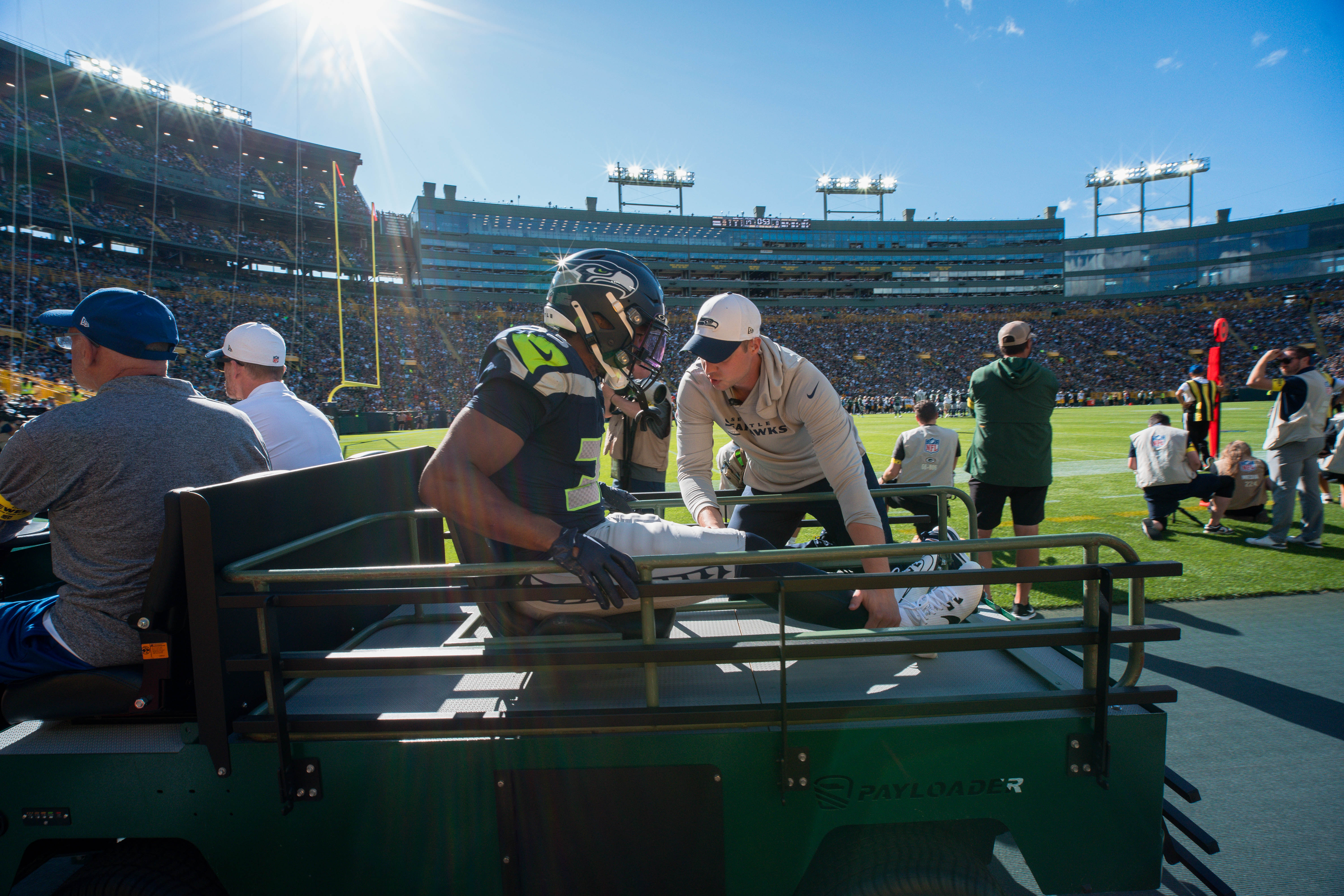 Seattle Seahawks cornerback Tyler Hall (33) leaves the field on a cart late in the second quarter against the Green Bay Packers at Lambeau Field on August 23, 2025 in Green Bay, Wisconsin. Photography by Ross Harried for Second Crop Sports.