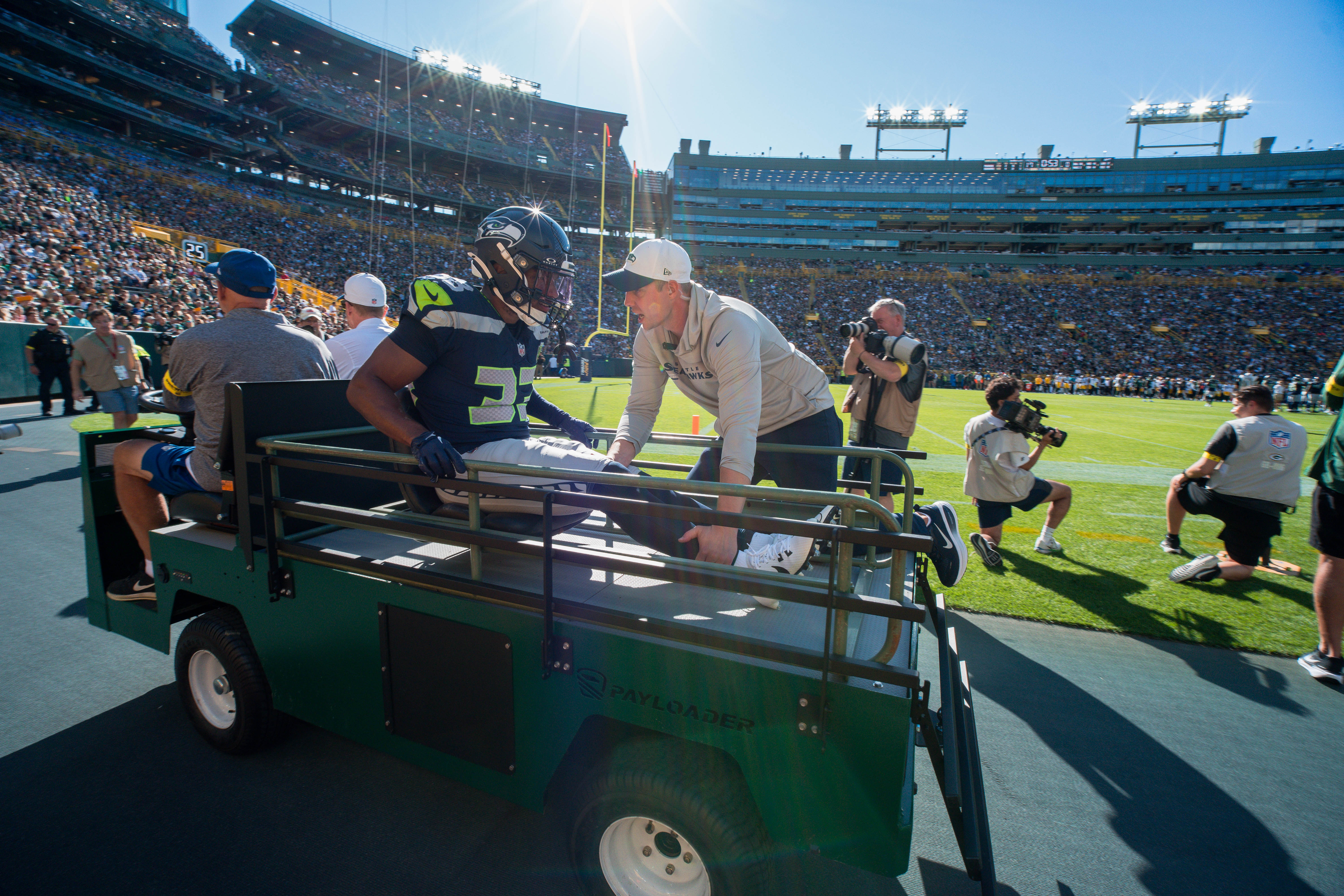Seattle Seahawks cornerback Tyler Hall (33) leaves the field on a cart late in the second quarter against the Green Bay Packers at Lambeau Field on August 23, 2025 in Green Bay, Wisconsin. Photography by Ross Harried for Second Crop Sports.