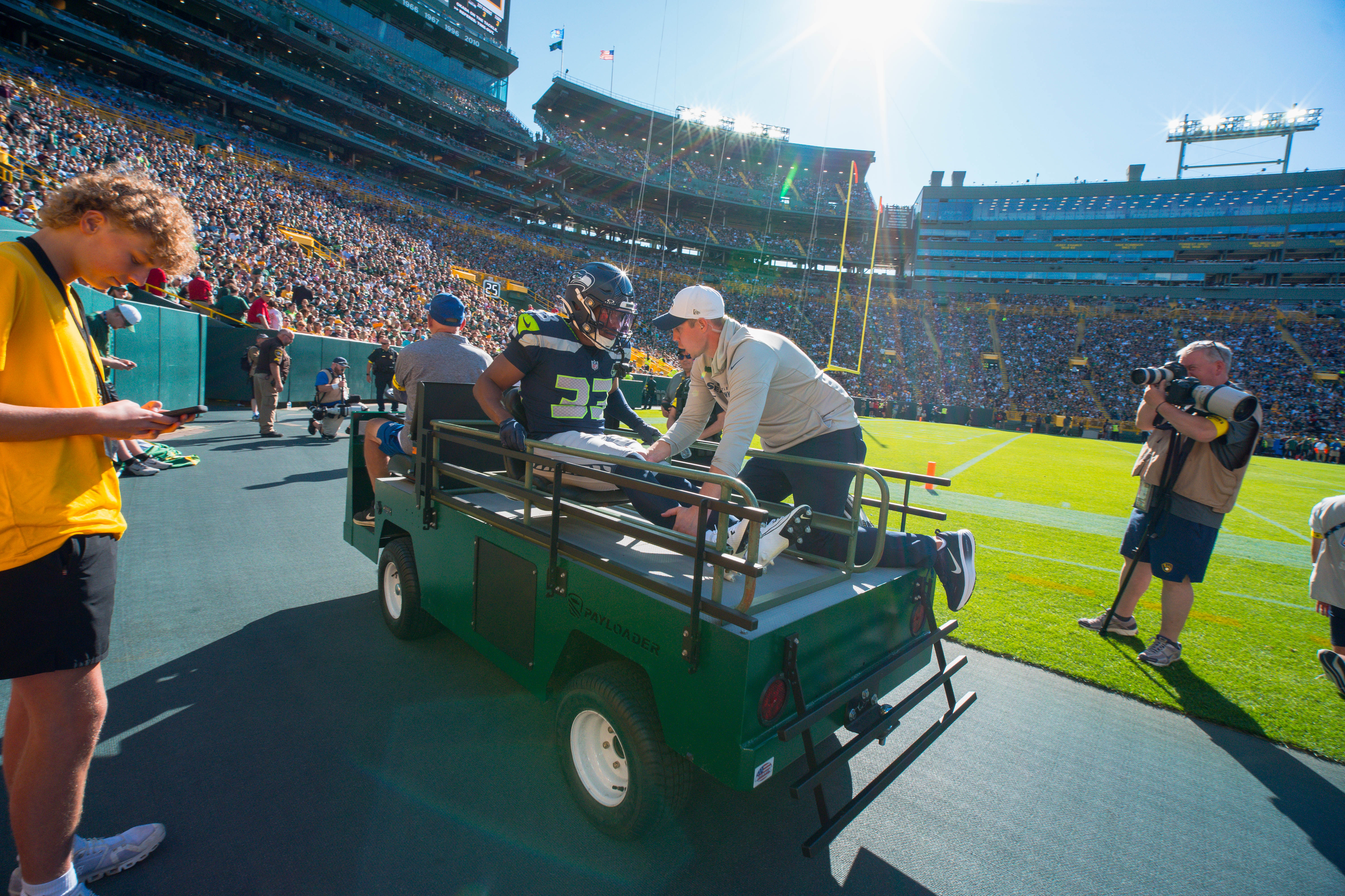 Seattle Seahawks cornerback Tyler Hall (33) leaves the field on a cart late in the second quarter against the Green Bay Packers at Lambeau Field on August 23, 2025 in Green Bay, Wisconsin. Photography by Ross Harried for Second Crop Sports.