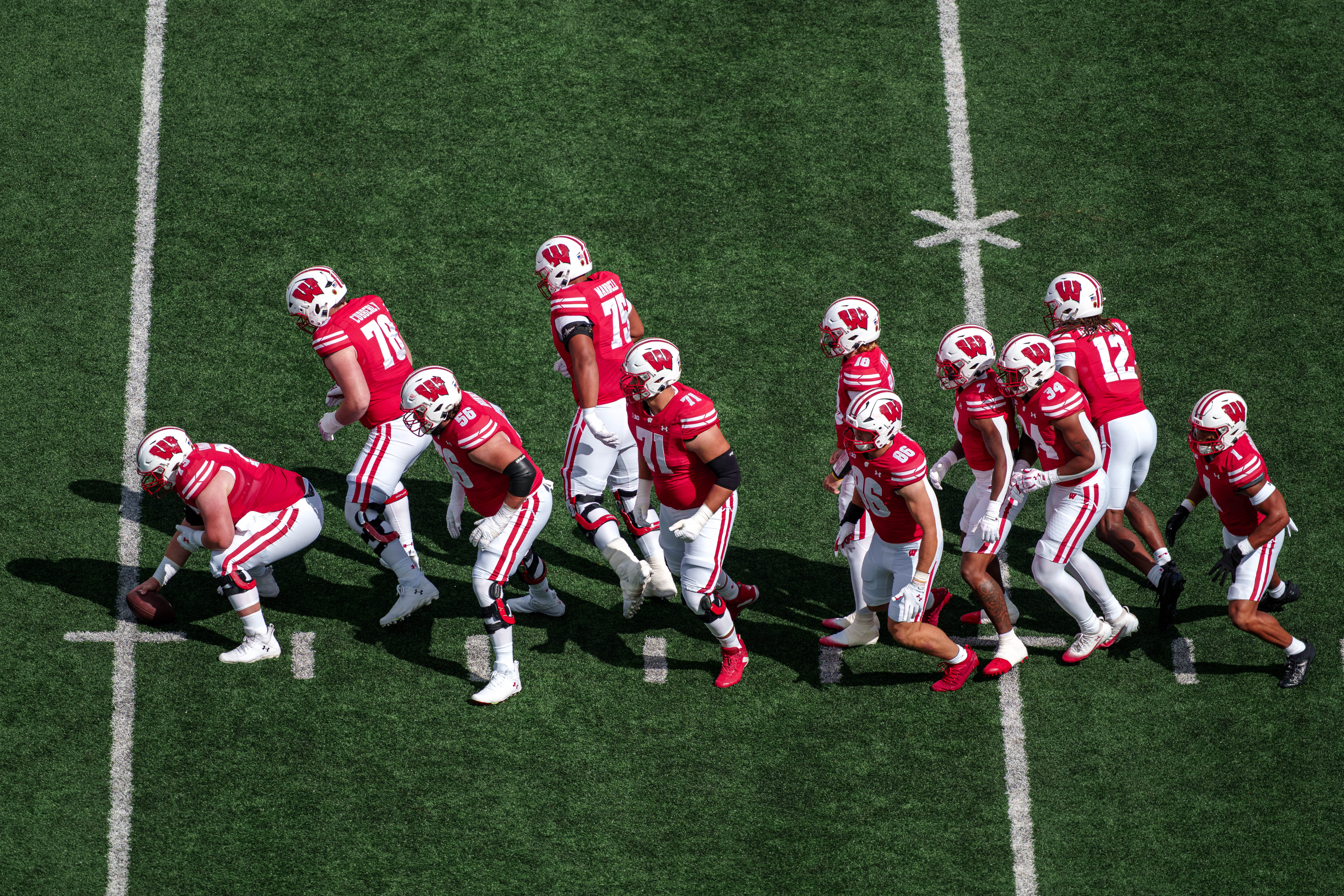 Sept 6, 2025; Madison, Wisconsin, USA; The Wisconsin Badgers Offense breaks out of a single file formation durning a college football game between the Wisconsin Badgers and the Middle Tennessee Blue Raiders at Camp Randall Stadium on September 06, 2025 in Madison, Wisconsin. Photography by Ross Harried for Second Crop Sports.