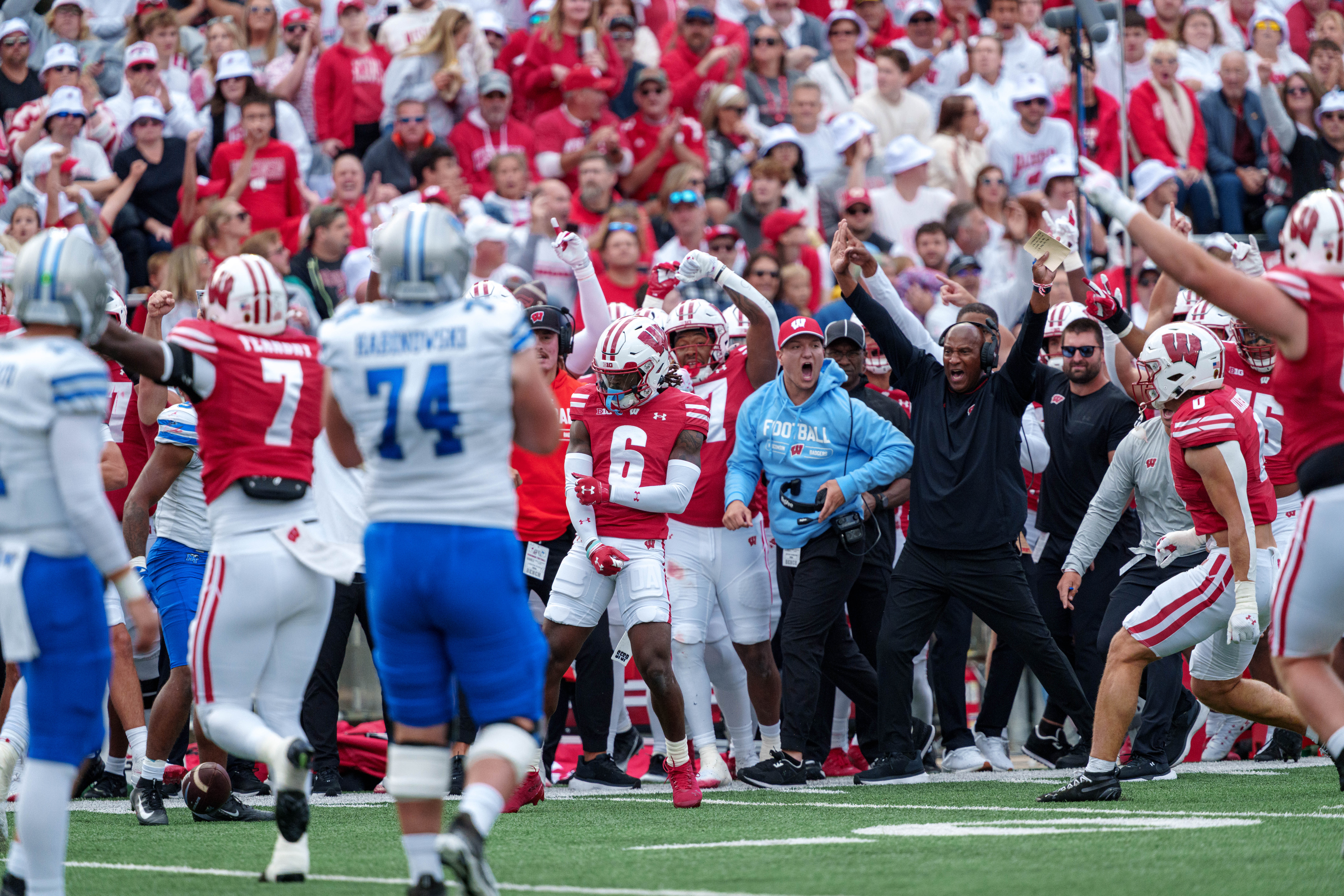 Sept 6, 2025; Madison, Wisconsin, USA; The Wisconsin Badgers sideline celebrates a Omillio Agard (6) interception durning a college football game between the Wisconsin Badgers and the Middle Tennessee Blue Raiders at Camp Randall Stadium on September 06, 2025 in Madison, Wisconsin. Photography by Ross Harried for Second Crop Sports.
