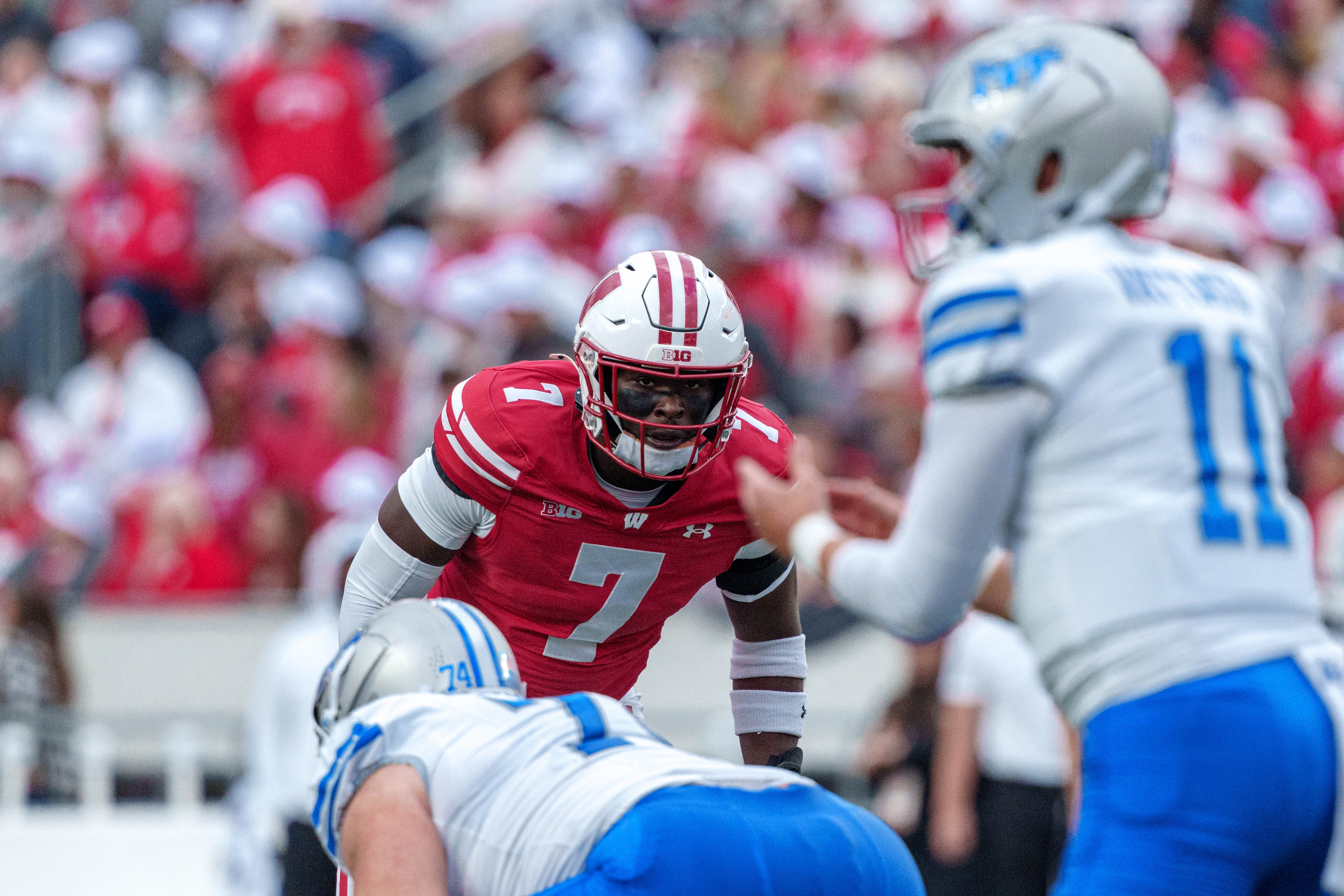 Sept 6, 2025; Madison, Wisconsin, USA; Wisconsin Badgers outside linebacker Tyreese Fearbry (7) eyes Middle Tennessee Blue Raiders quarterback Nicholas Vattiato (11) durning a college football game between the Wisconsin Badgers and the Middle Tennessee Blue Raiders at Camp Randall Stadium on September 06, 2025 in Madison, Wisconsin. Photography by Ross Harried for Second Crop Sports.