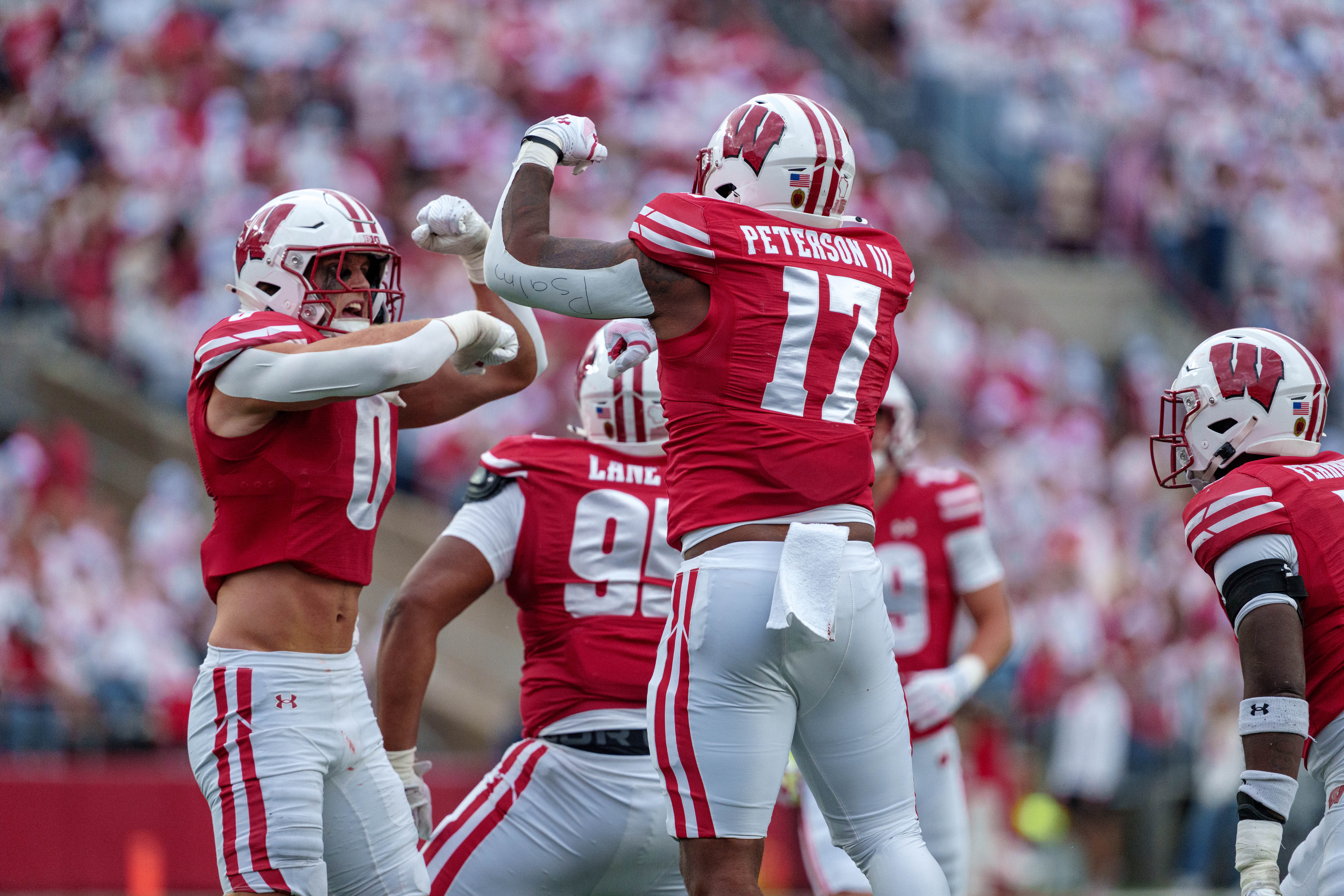 Sept 6, 2025; Madison, Wisconsin, USA; Wisconsin Badgers linebacker Christian Alliegro (0) & outside linebacker Darryl Peterson III (17) celebrate after the play durning a college football game between the Wisconsin Badgers and the Middle Tennessee Blue Raiders at Camp Randall Stadium on September 06, 2025 in Madison, Wisconsin. Photography by Ross Harried for Second Crop Sports.