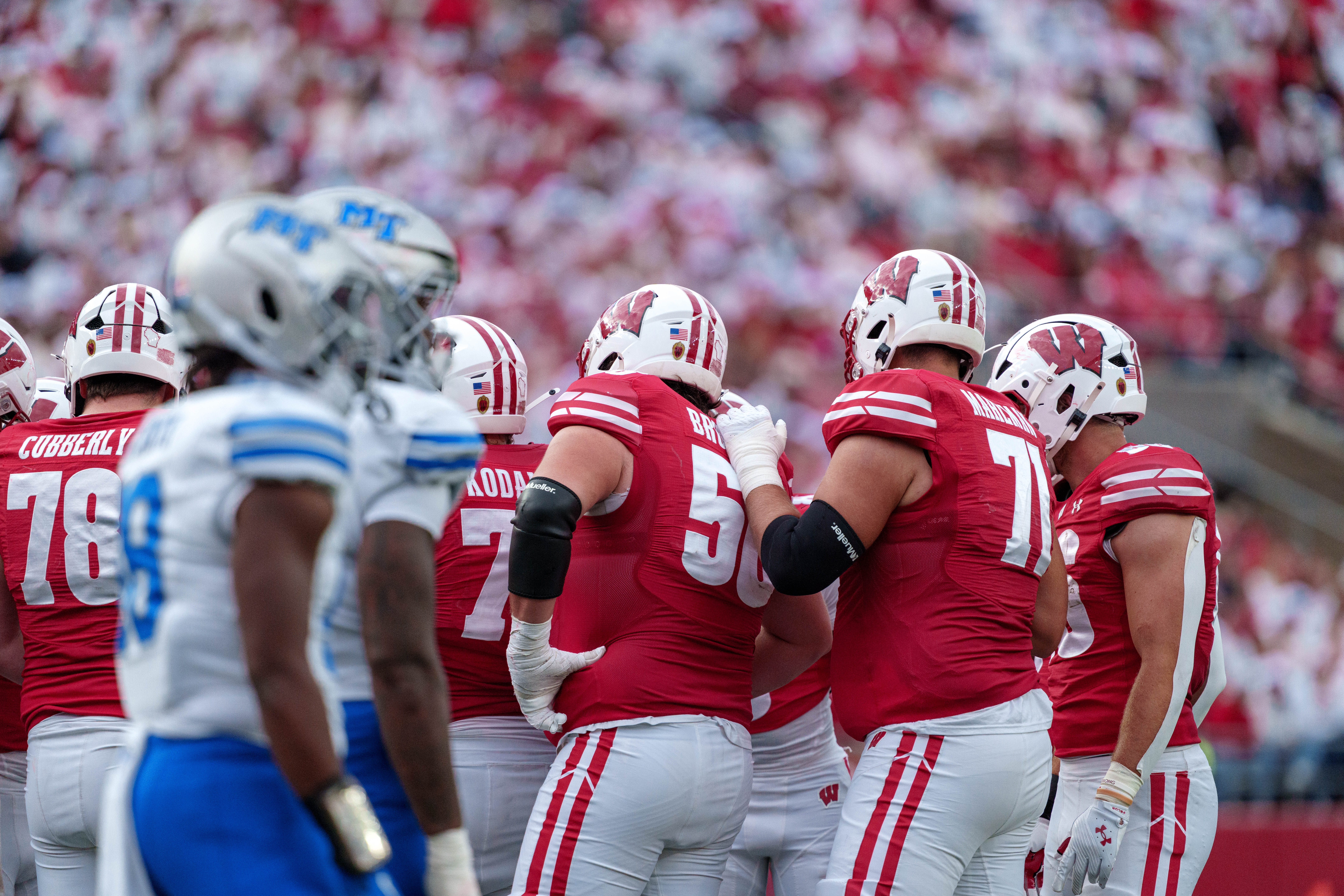 Sept 6, 2025; Madison, Wisconsin, USA; The Wisconsin Badgers offense huddles up durning a college football game between the Wisconsin Badgers and the Middle Tennessee Blue Raiders at Camp Randall Stadium on September 06, 2025 in Madison, Wisconsin. Photography by Ross Harried for Second Crop Sports.
