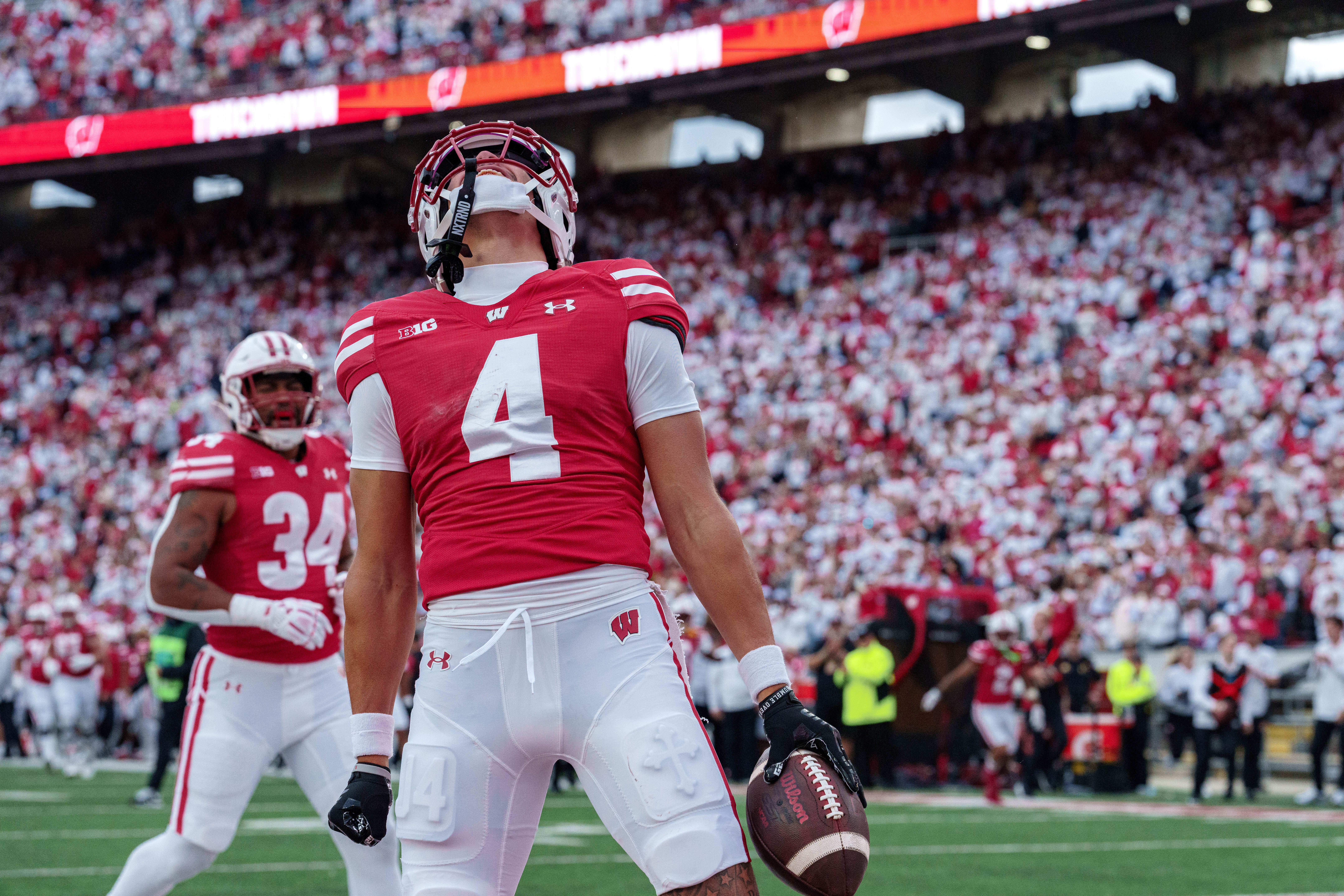 Sept 6, 2025; Madison, Wisconsin, USA; Wisconsin Badgers wide receiver Jayden Ballard (4) celebrates a touchdown durning a college football game between the Wisconsin Badgers and the Middle Tennessee Blue Raiders at Camp Randall Stadium on September 06, 2025 in Madison, Wisconsin. Photography by Ross Harried for Second Crop Sports.