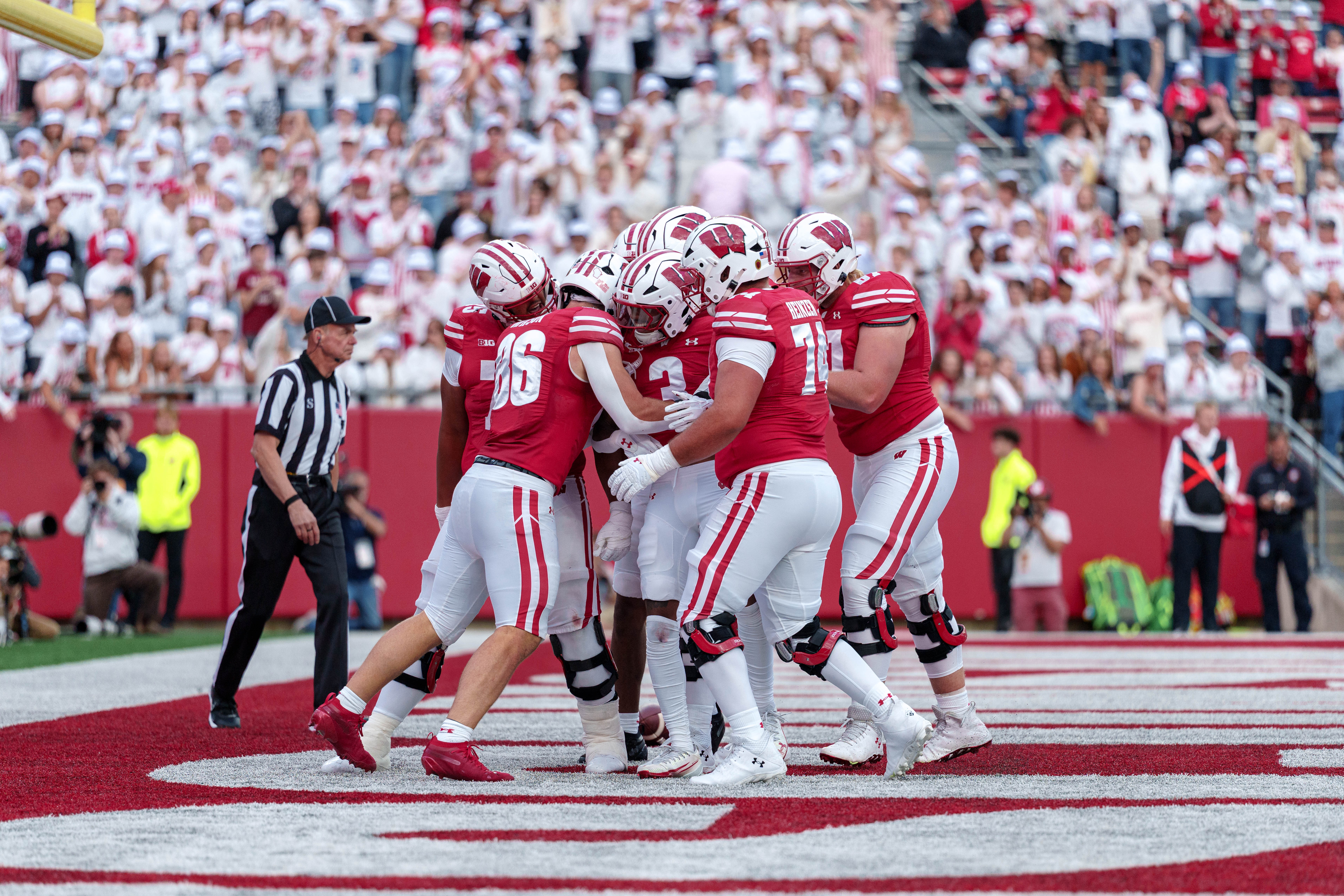 Sept 6, 2025; Madison, Wisconsin, USA; The Wisconsin Badgers offense celebrates a touchdown durning a college football game between the Wisconsin Badgers and the Middle Tennessee Blue Raiders at Camp Randall Stadium on September 06, 2025 in Madison, Wisconsin. Photography by Ross Harried for Second Crop Sports.