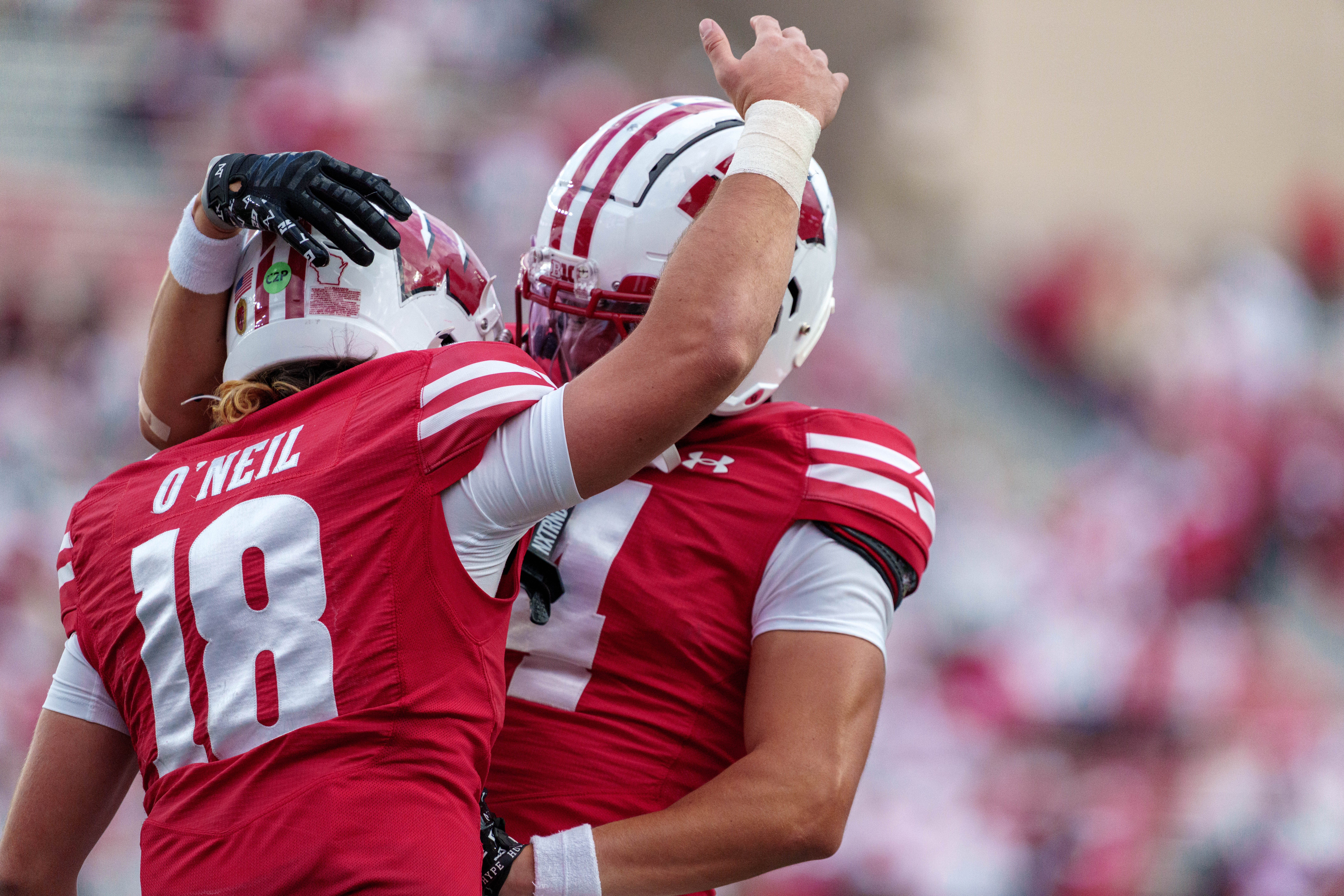 Sept 6, 2025; Madison, Wisconsin, USA; Wisconsin Badgers quarterback Danny O'Neil (18) and wide receiver Jayden Ballard (4) celebrate a touchdown durning a college football game between the Wisconsin Badgers and the Middle Tennessee Blue Raiders at Camp Randall Stadium on September 06, 2025 in Madison, Wisconsin. Photography by Ross Harried for Second Crop Sports.