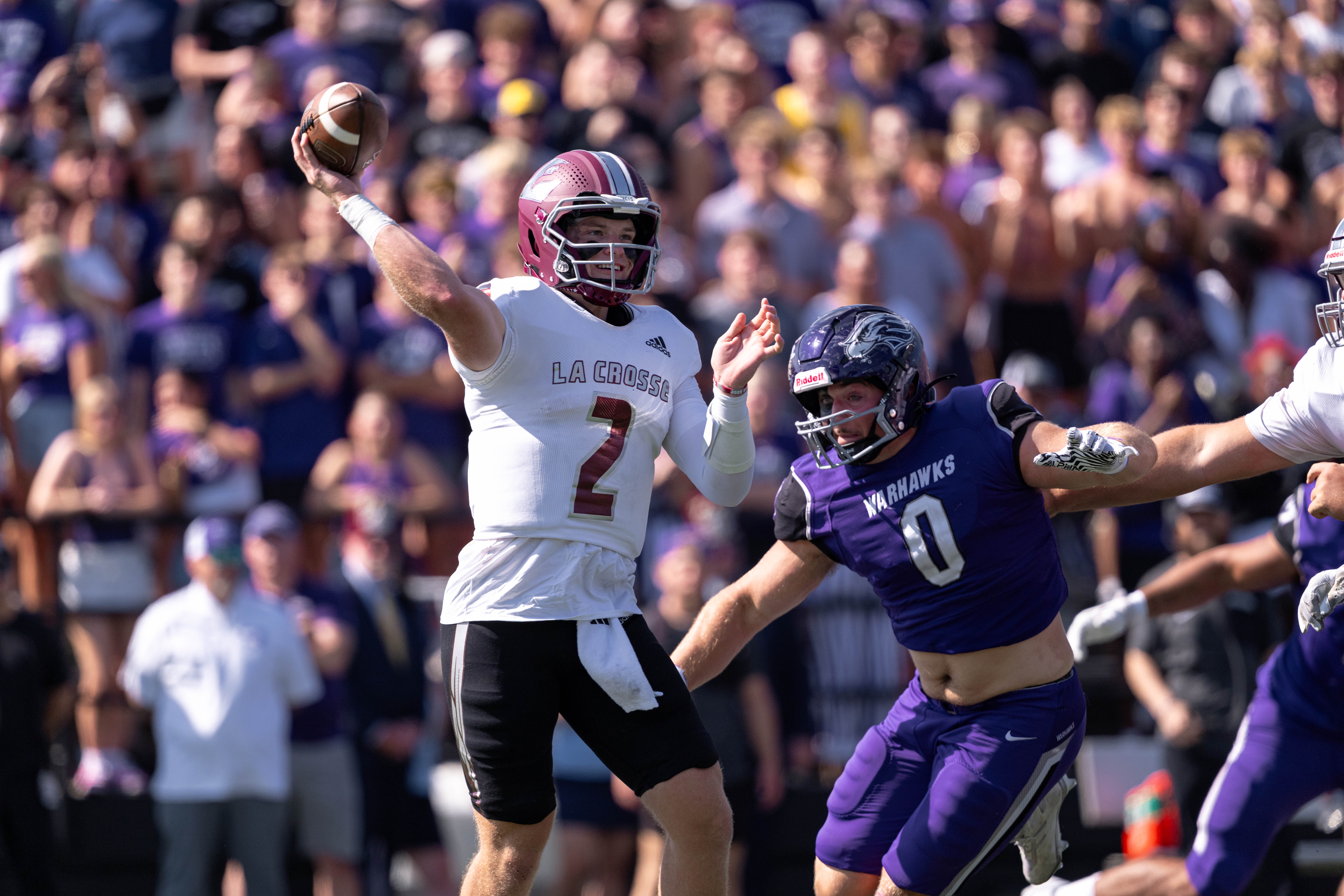 Oct 4, 2025; Whitewater, Wisconsin, USA; University of Wisconsin-La Crosse Eagles quarterback Kyle Haas (2) attempts a pass while being chased by University of Wisconsin-Whitewater Warhawks defensive lineman Noah Moris (0) at Perkins Stadium on October 04, 2025 in Whitewater, Wisconsin. Photography by Ross Harried for Second Crop Sports.