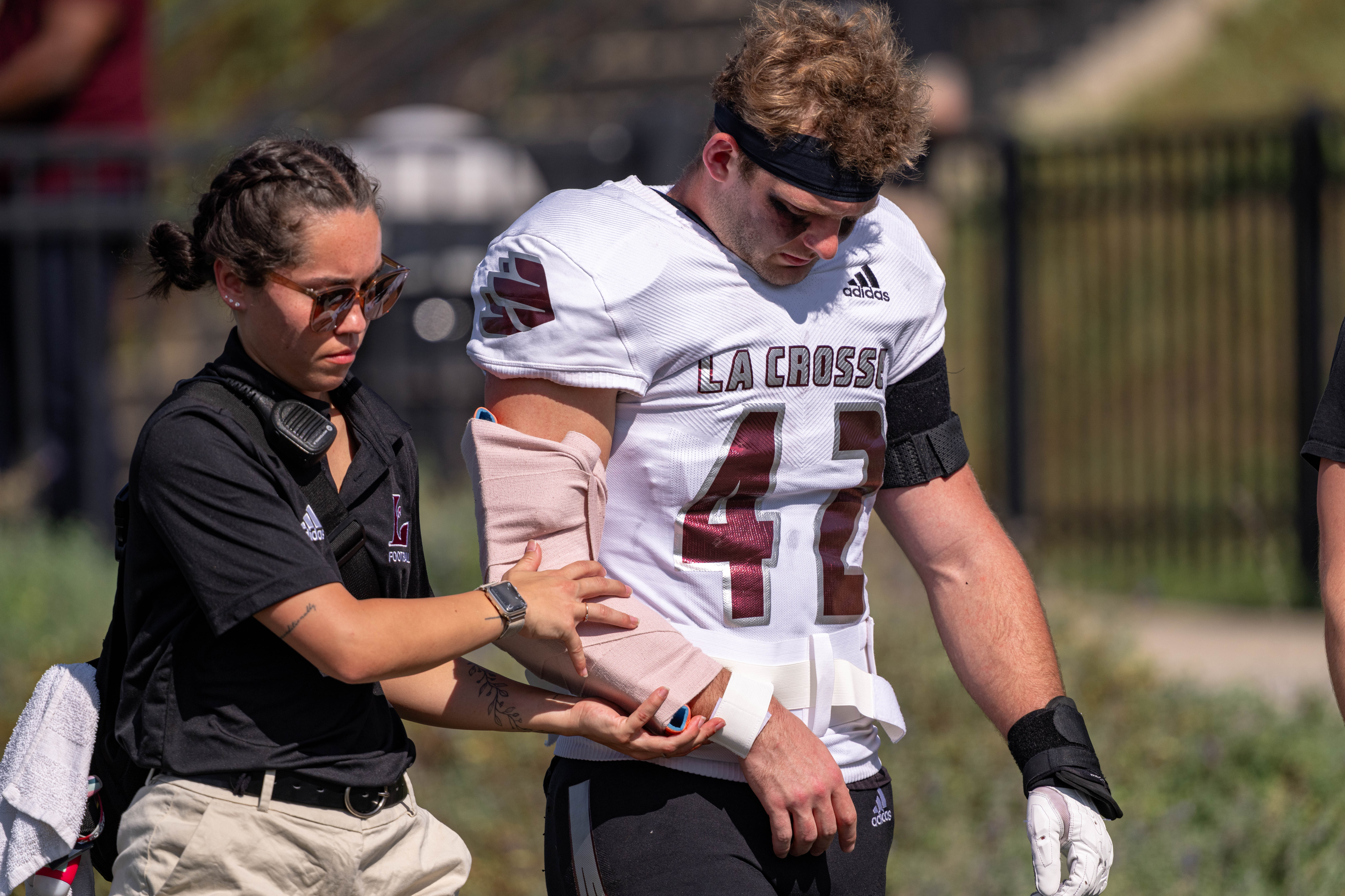 Oct 4, 2025; Whitewater, Wisconsin, USA; University of Wisconsin-La Crosse Eagles defensive lineman Isaac Dagit (42) gets attention after suffering an apparent arm injury durning a college football game between the University of Wisconsin-Whitewater Warhawks and the University of Wisconsin-La Crosse Eagles at Perkins Stadium on October 04, 2025 in Whitewater, Wisconsin. Photography by Ross Harried for Second Crop Sports.