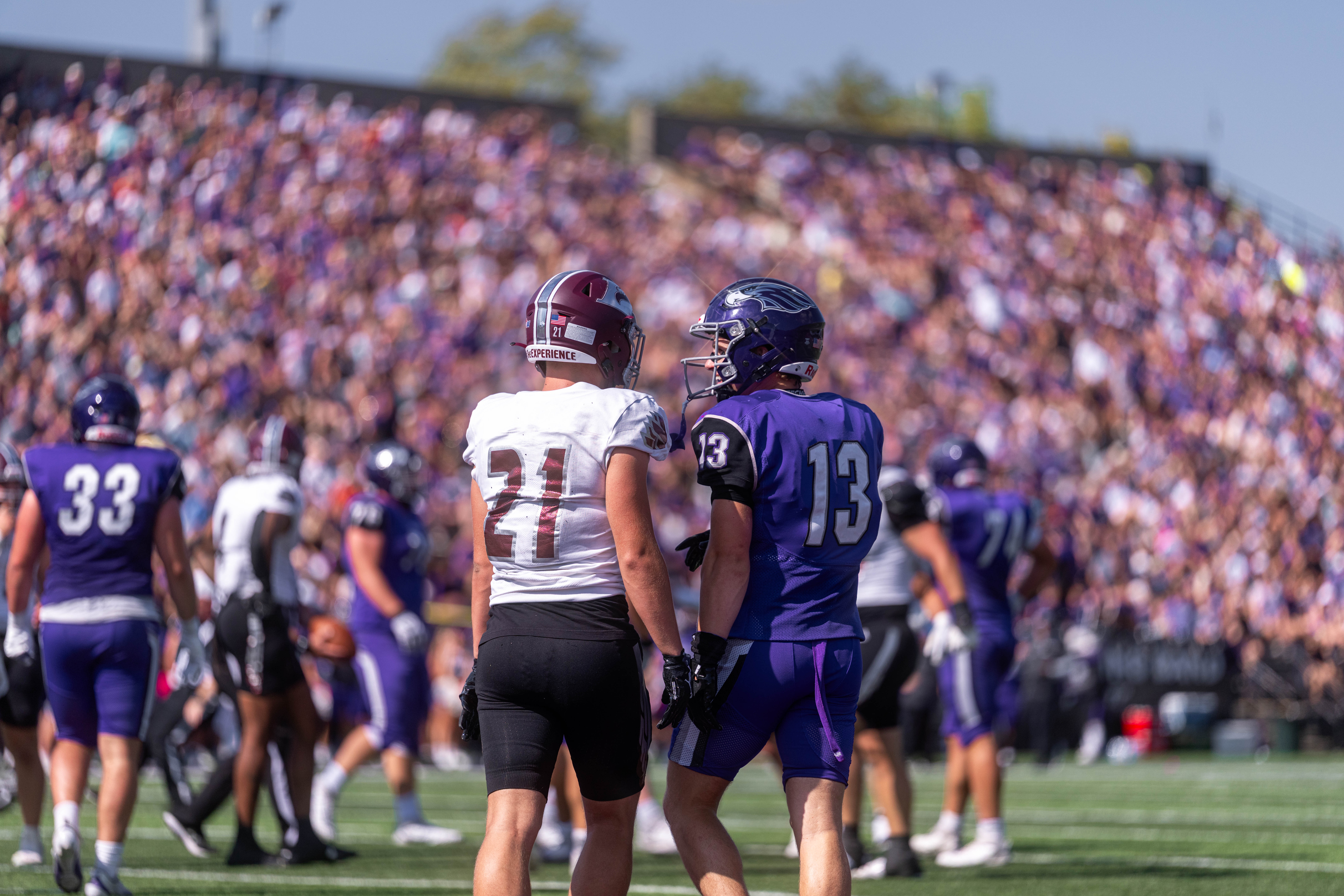 Oct 4, 2025; Whitewater, Wisconsin, USA; University of Wisconsin-La Crosse Eagles defensive back Trent Mullen (21) and University of Wisconsin-Whitewater Warhawks wide receiver Blake Haggerty (13) exchange words after a play durning a college football game between the University of Wisconsin-Whitewater Warhawks and the University of Wisconsin-La Crosse Eagles at Perkins Stadium on October 04, 2025 in Whitewater, Wisconsin. Photography by Ross Harried for Second Crop Sports.