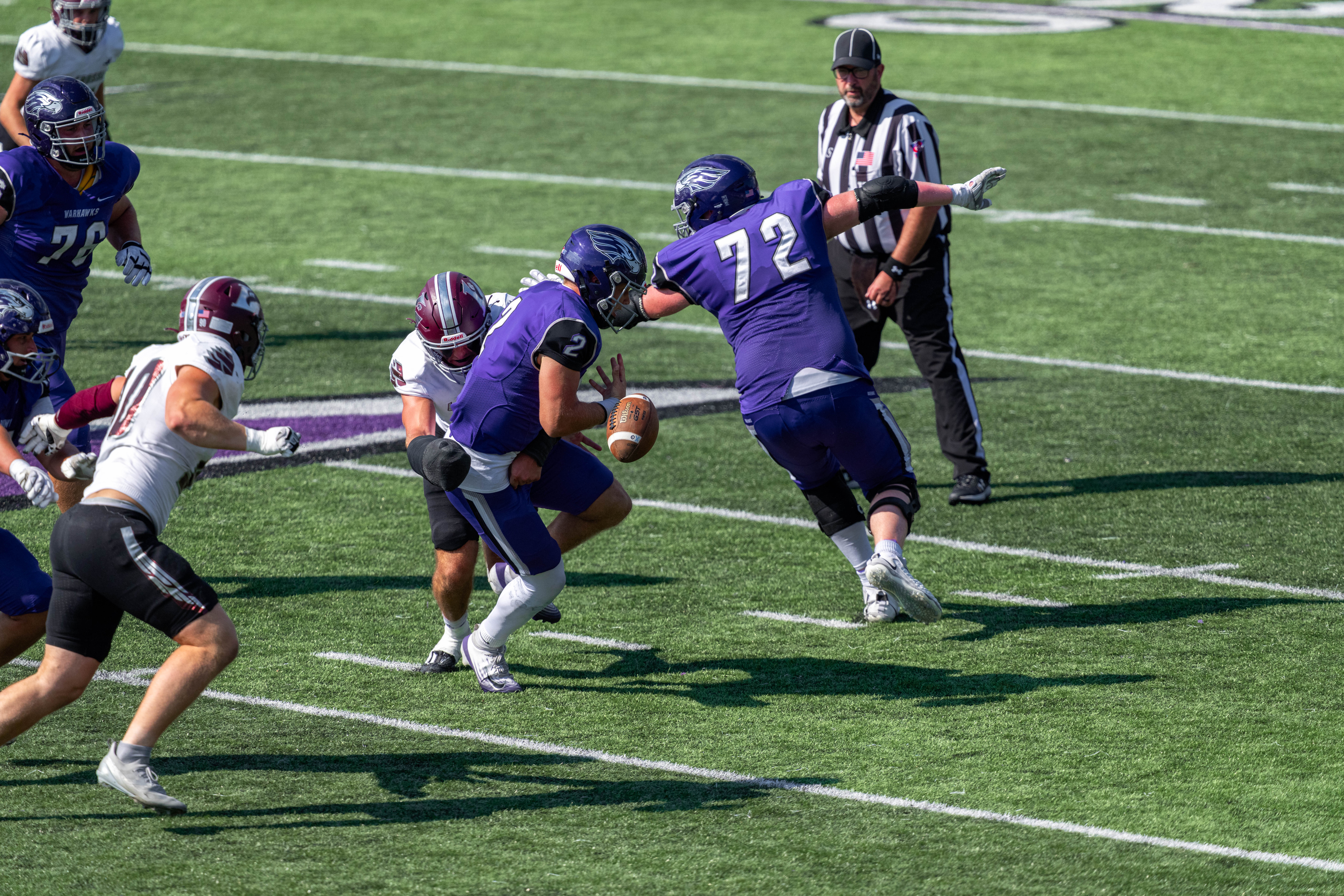 Oct 4, 2025; Whitewater, Wisconsin, USA; University of Wisconsin-Whitewater Warhawks quarterback Justin Klinkner (2) fumbles the ball durning a college football game between the University of Wisconsin-Whitewater Warhawks and the University of Wisconsin-La Crosse Eagles at Perkins Stadium on October 04, 2025 in Whitewater, Wisconsin. Photography by Ross Harried for Second Crop Sports.