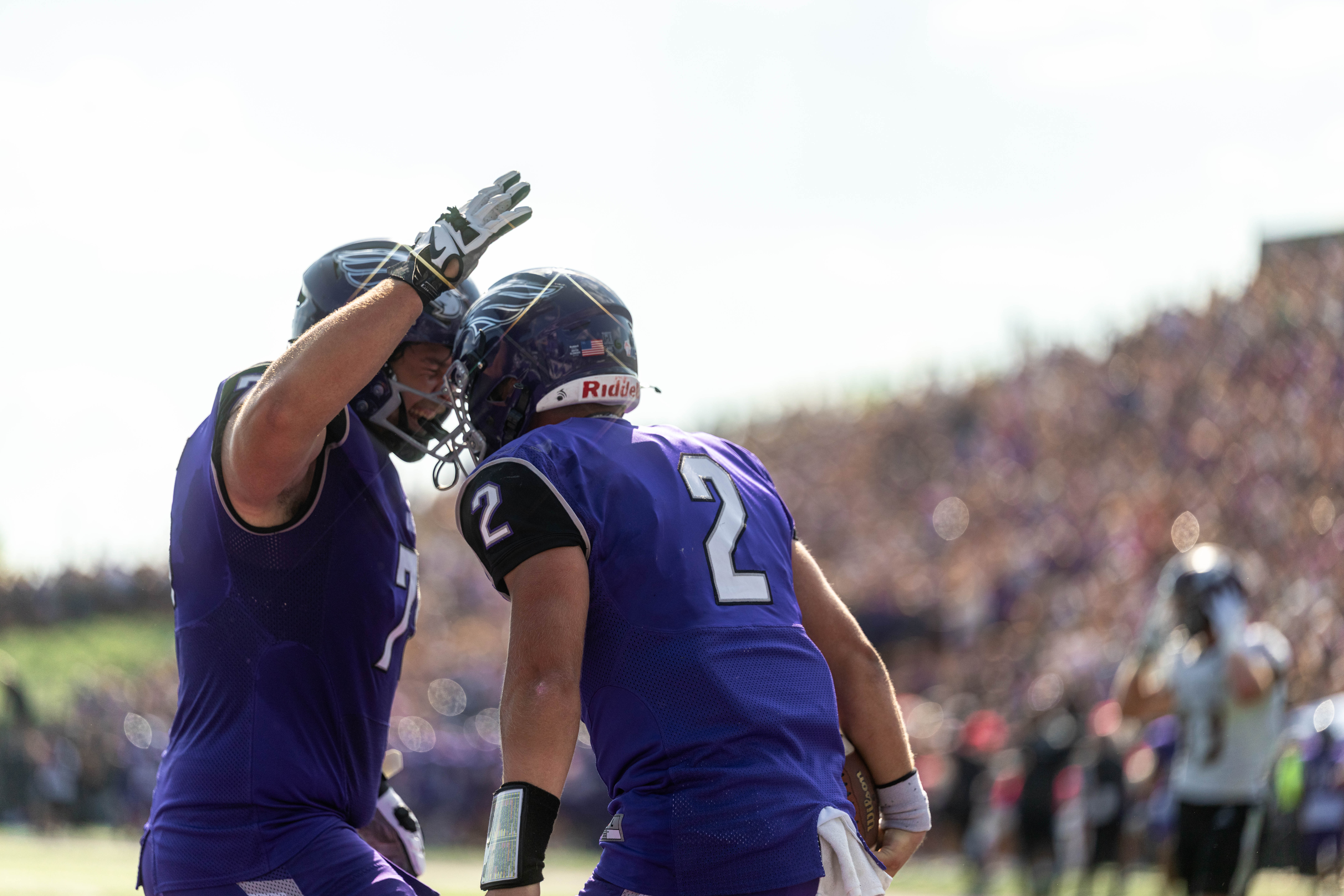 Oct 4, 2025; Whitewater, Wisconsin, USA; University of Wisconsin-Whitewater Warhawks quarterback Justin Klinkner (2) and offensive lineman Alex Pethan (75) celebrate a touchdown durning a college football game between the University of Wisconsin-Whitewater Warhawks and the University of Wisconsin-La Crosse Eagles at Perkins Stadium on October 04, 2025 in Whitewater, Wisconsin. Photography by Ross Harried for Second Crop Sports.