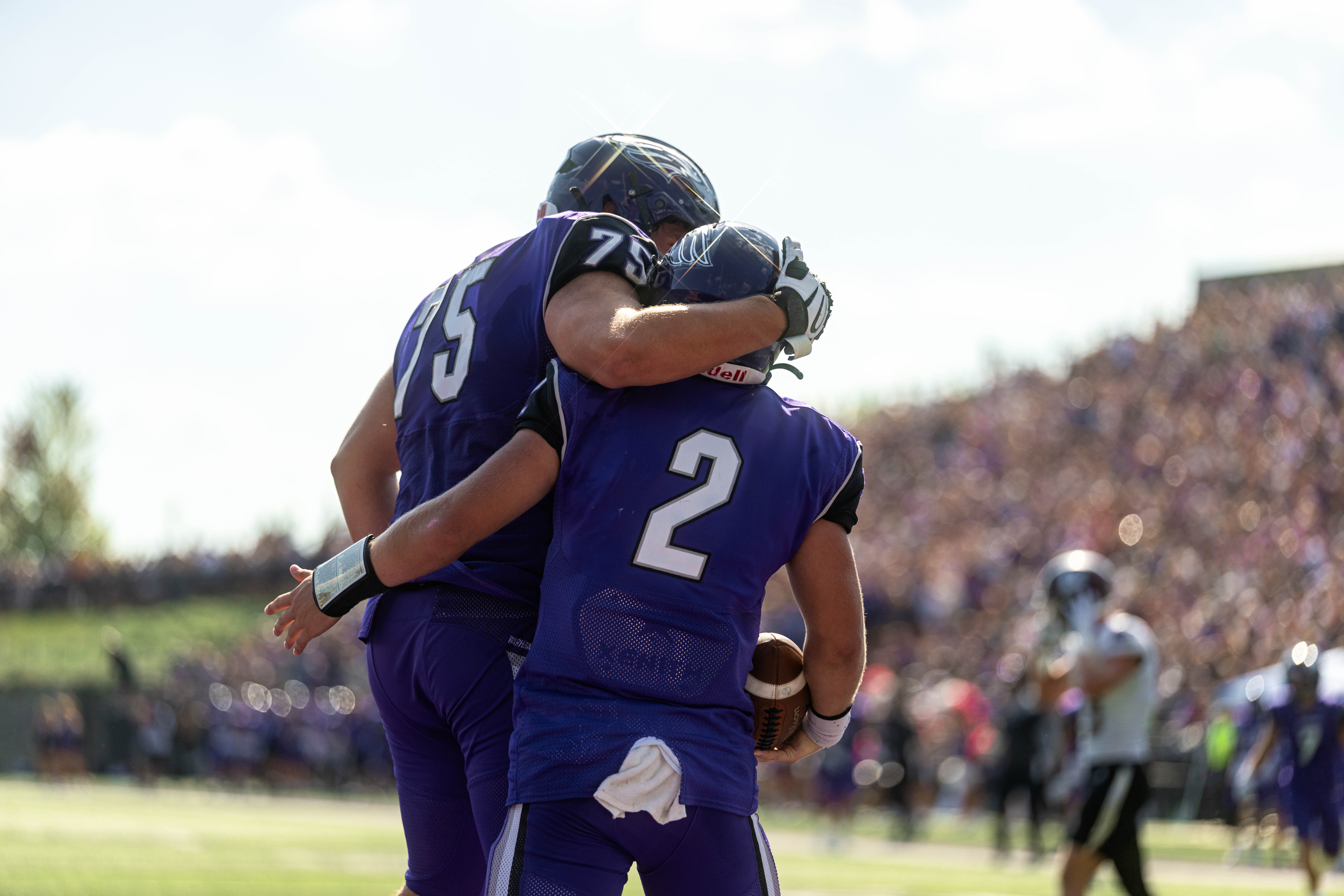 Oct 4, 2025; Whitewater, Wisconsin, USA; University of Wisconsin-Whitewater Warhawks quarterback Justin Klinkner (2) and offensive lineman Alex Pethan (75) celebrate a touchdown durning a college football game between the University of Wisconsin-Whitewater Warhawks and the University of Wisconsin-La Crosse Eagles at Perkins Stadium on October 04, 2025 in Whitewater, Wisconsin. Photography by Ross Harried for Second Crop Sports.