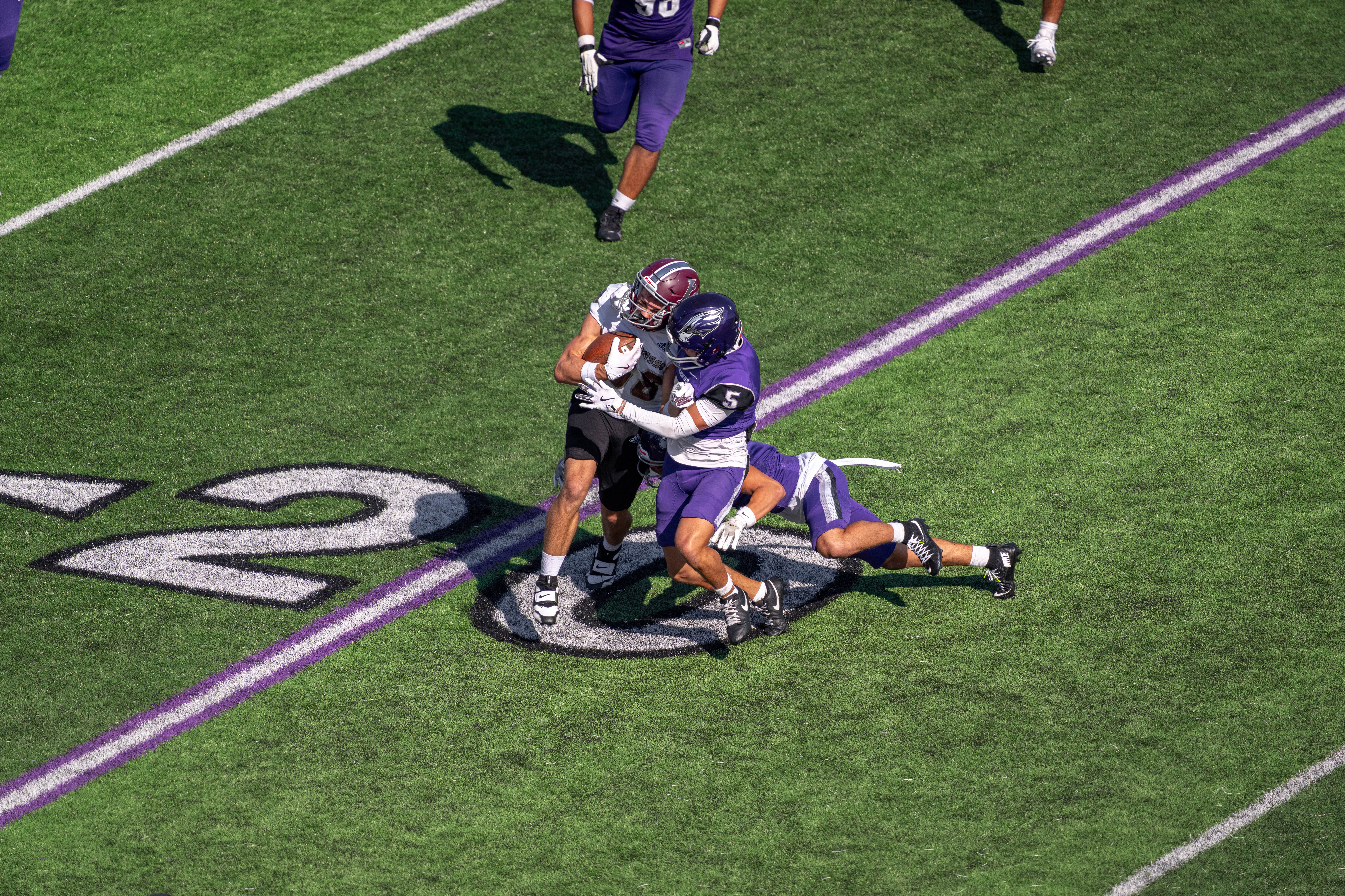 Oct 4, 2025; Whitewater, Wisconsin, USA; University of Wisconsin-Whitewater Warhawks defensive back Paul Kim (5) hits University of Wisconsin-La Crosse Eagles wide receiver Jacob Koon (86) durning a college football game between the University of Wisconsin-Whitewater Warhawks and the University of Wisconsin-La Crosse Eagles at Perkins Stadium on October 04, 2025 in Whitewater, Wisconsin. Photography by Ross Harried for Second Crop Sports.