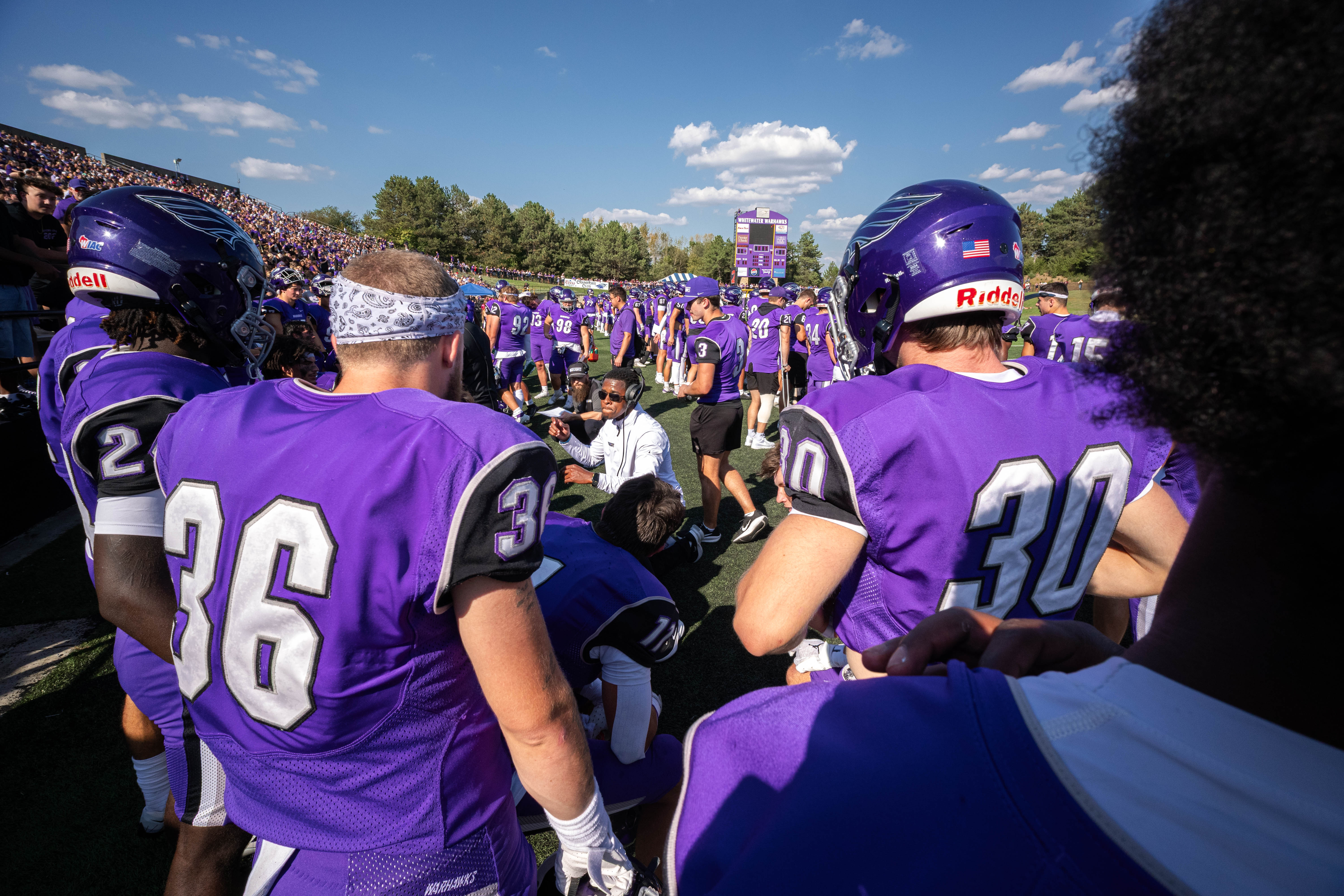 Oct 4, 2025; Whitewater, Wisconsin, USA; Defensive backs coach Bryce Cross talks with players durning a college football game between the University of Wisconsin-Whitewater Warhawks and the University of Wisconsin-La Crosse Eagles at Perkins Stadium on October 04, 2025 in Whitewater, Wisconsin. Photography by Ross Harried for Second Crop Sports.