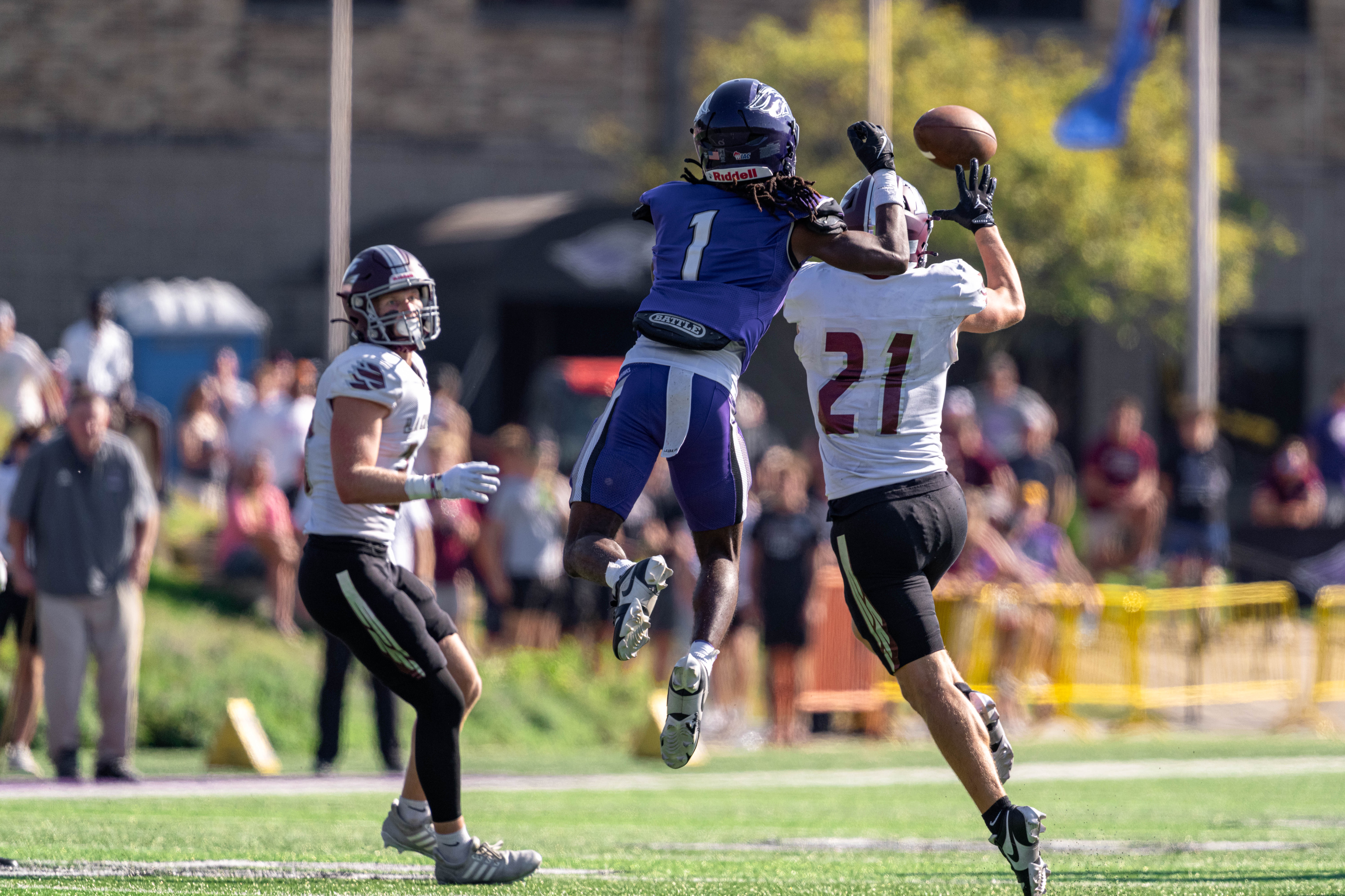 Oct 4, 2025; Whitewater, Wisconsin, USA; University of Wisconsin-La Crosse Eagles defensive back Trent Mullen (21) jumps in front of University of Wisconsin-Whitewater Warhawks wide receiver Christian Crump (1) for an interception durning a college football game between the University of Wisconsin-Whitewater Warhawks and the University of Wisconsin-La Crosse Eagles at Perkins Stadium on October 04, 2025 in Whitewater, Wisconsin. Photography by Ross Harried for Second Crop Sports.