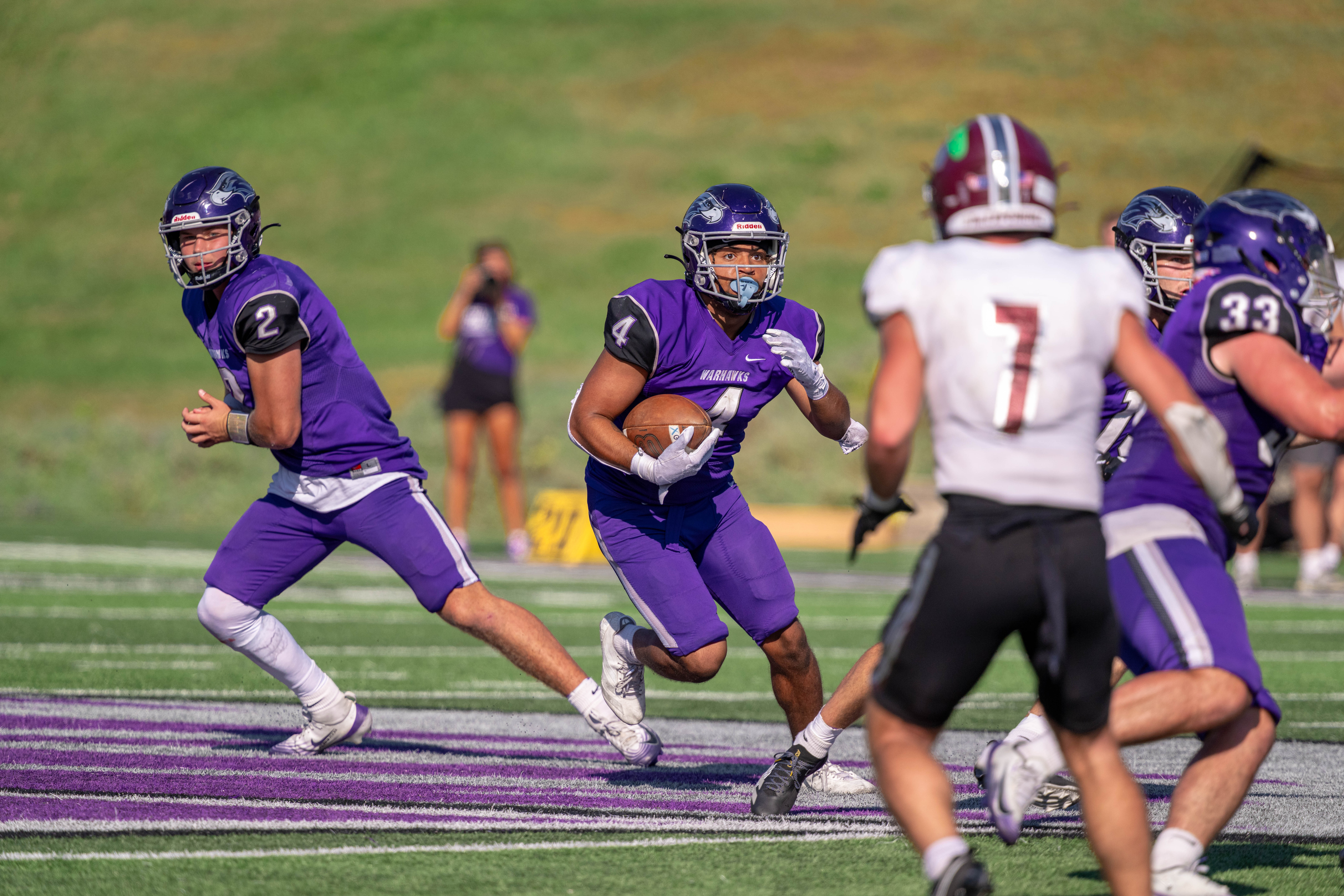 Oct 4, 2025; Whitewater, Wisconsin, USA; University of Wisconsin-Whitewater Warhawks running back Noah Battle (4) runs the ball durning a college football game between the University of Wisconsin-Whitewater Warhawks and the University of Wisconsin-La Crosse Eagles at Perkins Stadium on October 04, 2025 in Whitewater, Wisconsin. Photography by Ross Harried for Second Crop Sports.