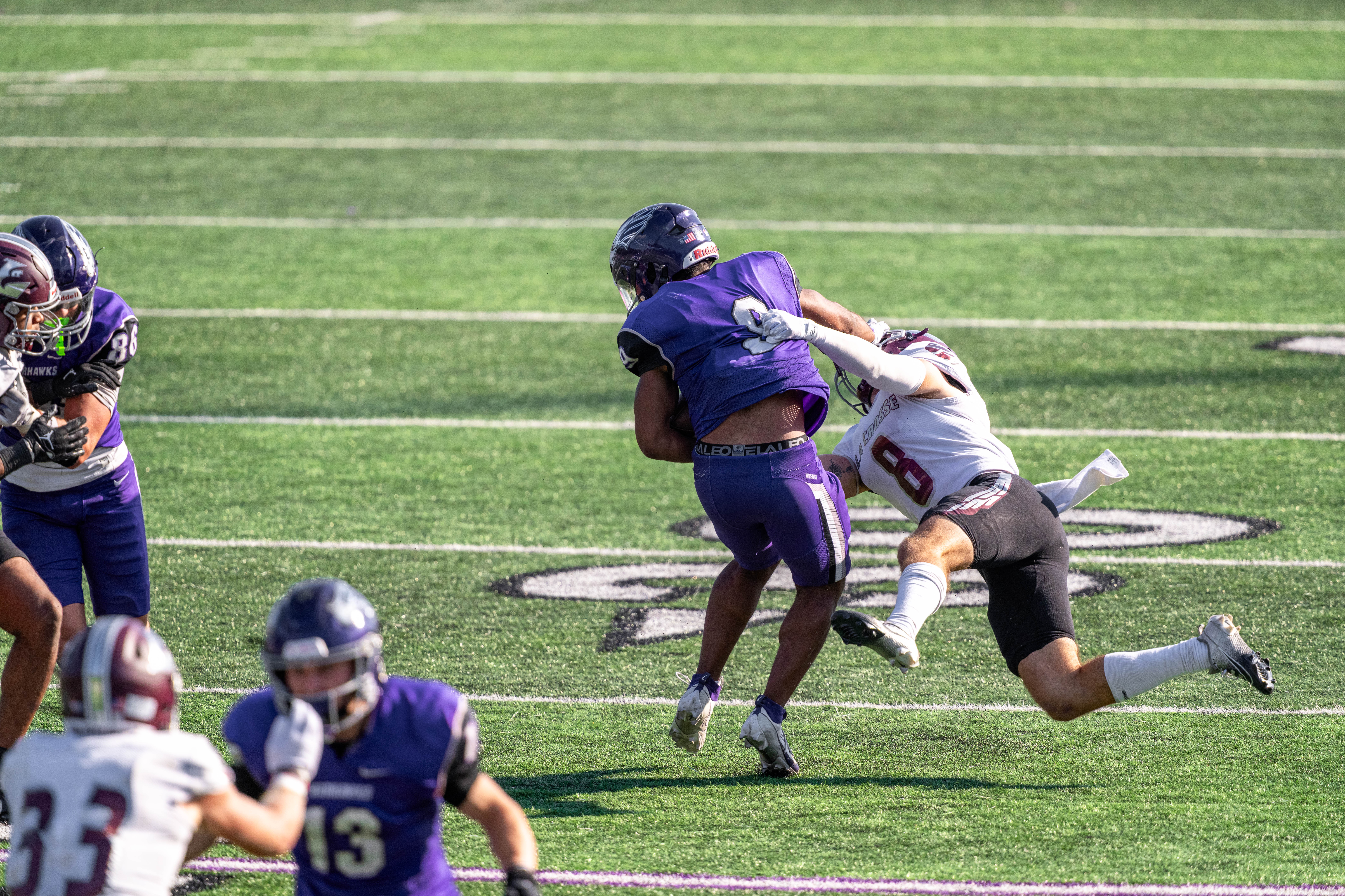 Oct 4, 2025; Whitewater, Wisconsin, USA; University of Wisconsin-Whitewater Warhawks running back Brian Stanton (9) sheds the tackle of University of Wisconsin-La Crosse Eagles defensive back Tyler Shaver (8) durning a college football game between the University of Wisconsin-Whitewater Warhawks and the University of Wisconsin-La Crosse Eagles at Perkins Stadium on October 04, 2025 in Whitewater, Wisconsin. Photography by Ross Harried for Second Crop Sports.