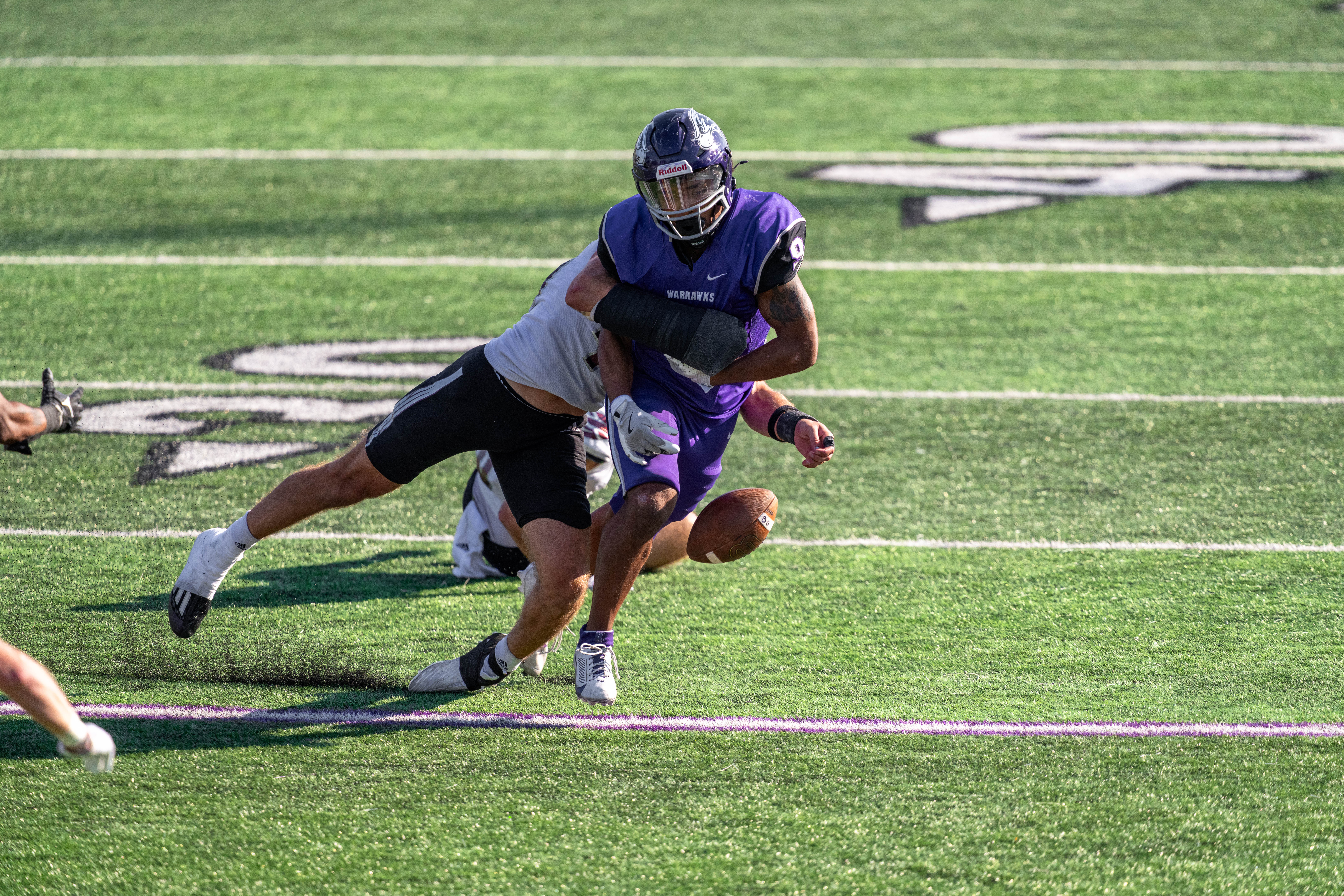 Oct 4, 2025; Whitewater, Wisconsin, USA; University of Wisconsin-La Crosse Eagles linebacker Aaron Winters (45) forces a fumble from University of Wisconsin-Whitewater Warhawks running back Brian Stanton (9) durning a college football game between the University of Wisconsin-Whitewater Warhawks and the University of Wisconsin-La Crosse Eagles at Perkins Stadium on October 04, 2025 in Whitewater, Wisconsin. Photography by Ross Harried for Second Crop Sports.