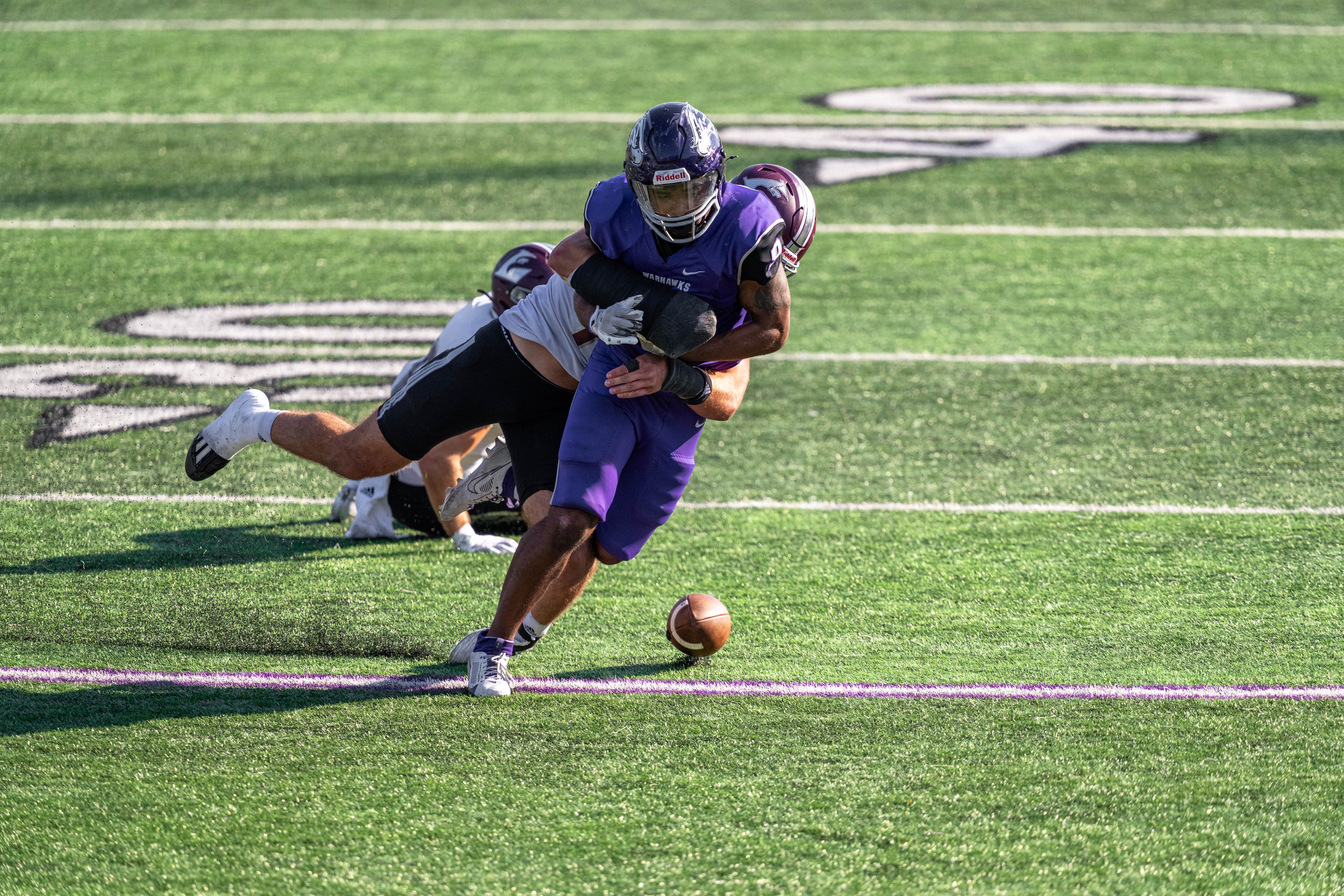 Oct 4, 2025; Whitewater, Wisconsin, USA; University of Wisconsin-La Crosse Eagles linebacker Aaron Winters (45) forces a fumble from University of Wisconsin-Whitewater Warhawks running back Brian Stanton (9) durning a college football game between the University of Wisconsin-Whitewater Warhawks and the University of Wisconsin-La Crosse Eagles at Perkins Stadium on October 04, 2025 in Whitewater, Wisconsin. Photography by Ross Harried for Second Crop Sports.