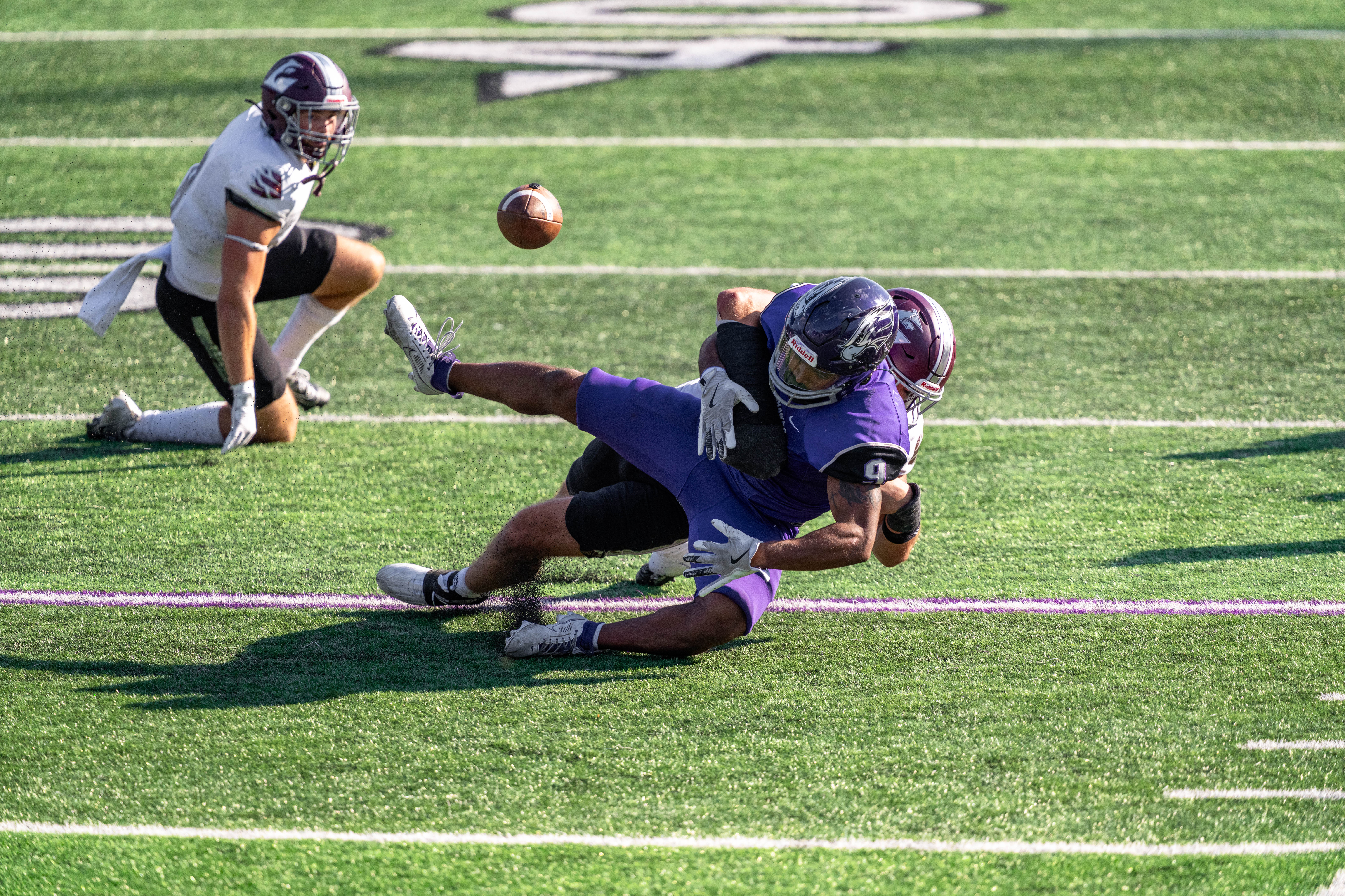 Oct 4, 2025; Whitewater, Wisconsin, USA; University of Wisconsin-La Crosse Eagles linebacker Aaron Winters (45) forces a fumble from University of Wisconsin-Whitewater Warhawks running back Brian Stanton (9) durning a college football game between the University of Wisconsin-Whitewater Warhawks and the University of Wisconsin-La Crosse Eagles at Perkins Stadium on October 04, 2025 in Whitewater, Wisconsin. Photography by Ross Harried for Second Crop Sports.