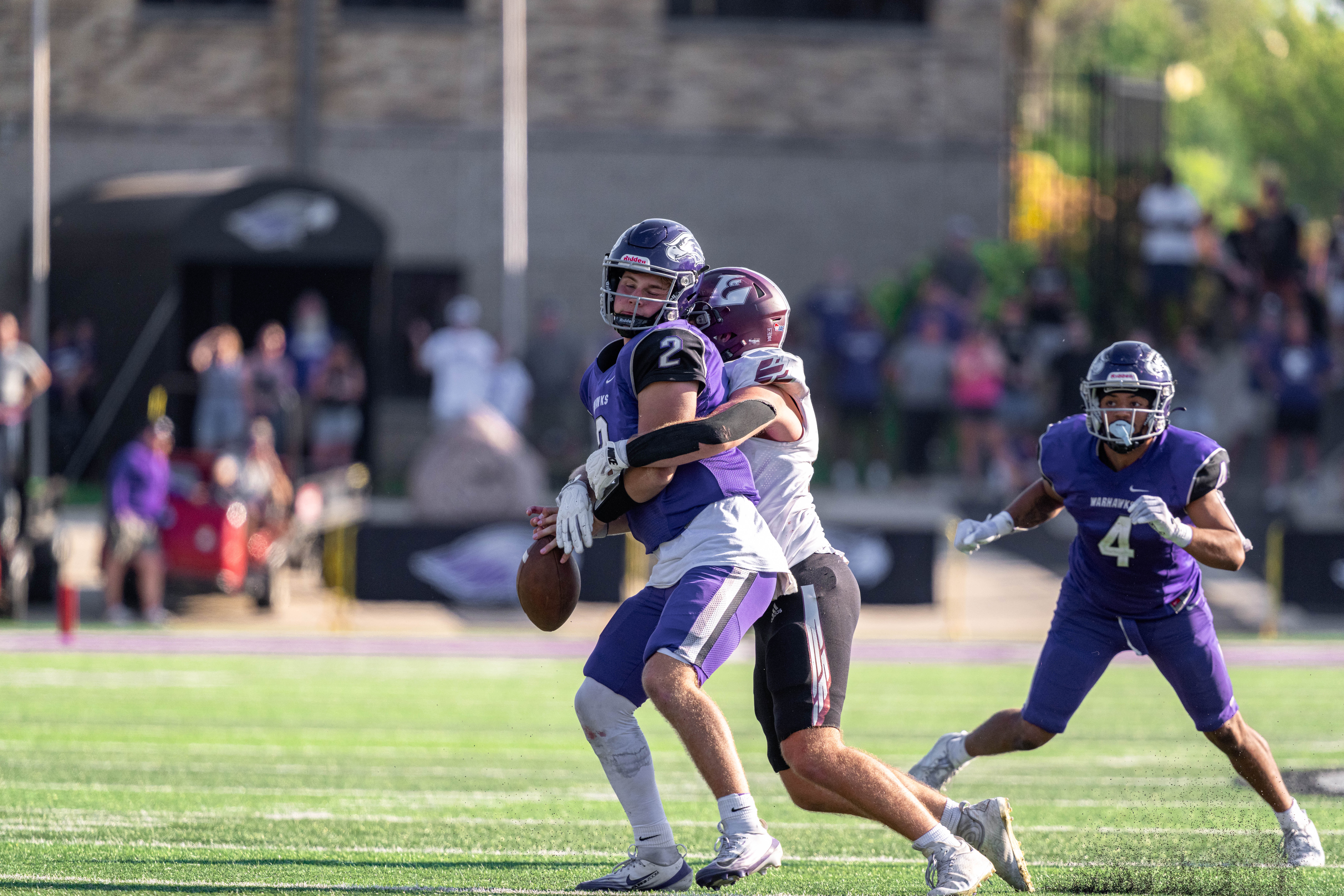 Oct 4, 2025; Whitewater, Wisconsin, USA; University of Wisconsin-La Crosse Eagles defensive lineman Ben Moore (55) sacks University of Wisconsin-Whitewater Warhawks quarterback Justin Klinkner (2) forcing a fumble durning a college football game between the University of Wisconsin-Whitewater Warhawks and the University of Wisconsin-La Crosse Eagles at Perkins Stadium on October 04, 2025 in Whitewater, Wisconsin. Photography by Ross Harried for Second Crop Sports.