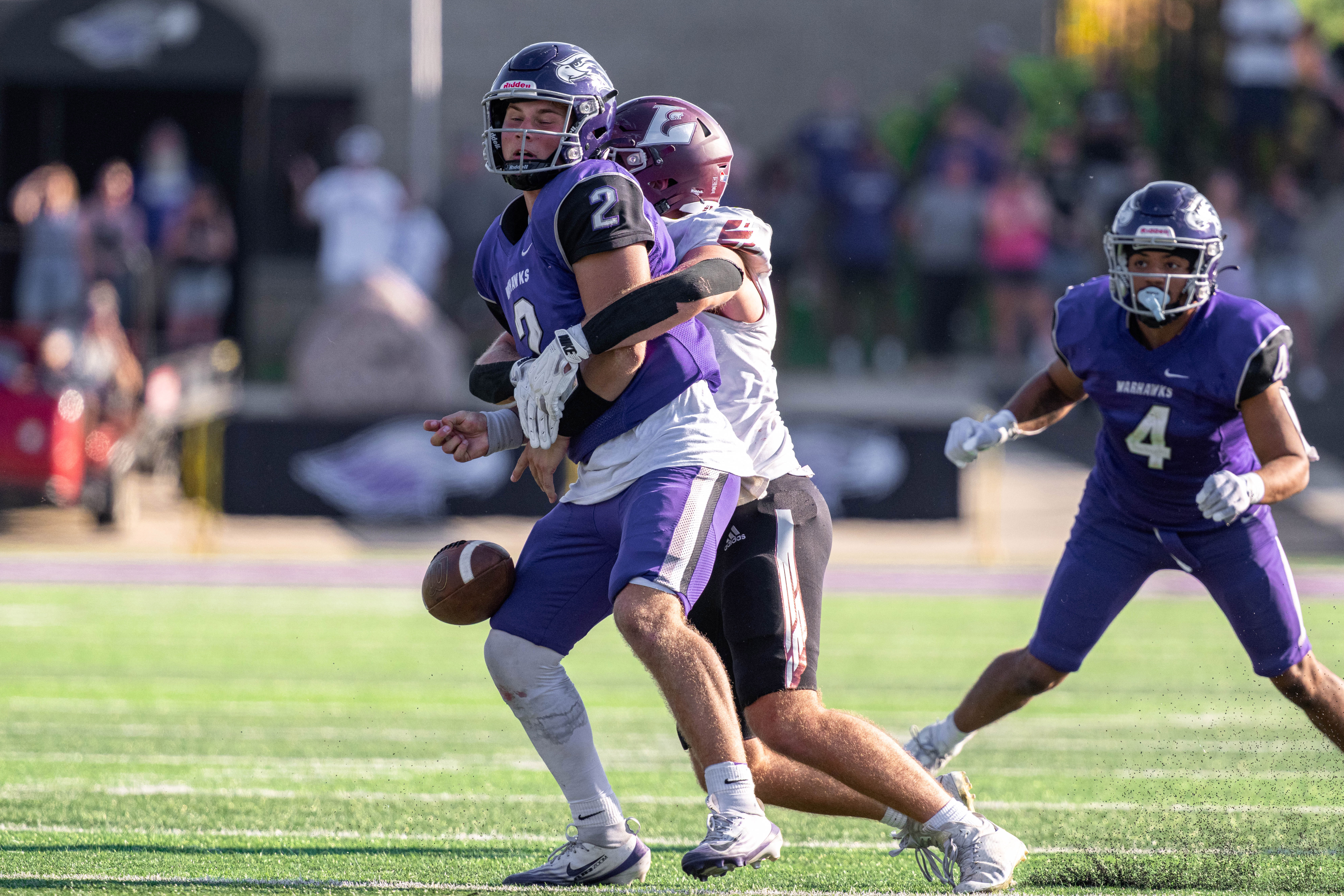 Oct 4, 2025; Whitewater, Wisconsin, USA; University of Wisconsin-La Crosse Eagles defensive lineman Ben Moore (55) sacks University of Wisconsin-Whitewater Warhawks quarterback Justin Klinkner (2) forcing a fumble durning a college football game between the University of Wisconsin-Whitewater Warhawks and the University of Wisconsin-La Crosse Eagles at Perkins Stadium on October 04, 2025 in Whitewater, Wisconsin. Photography by Ross Harried for Second Crop Sports.