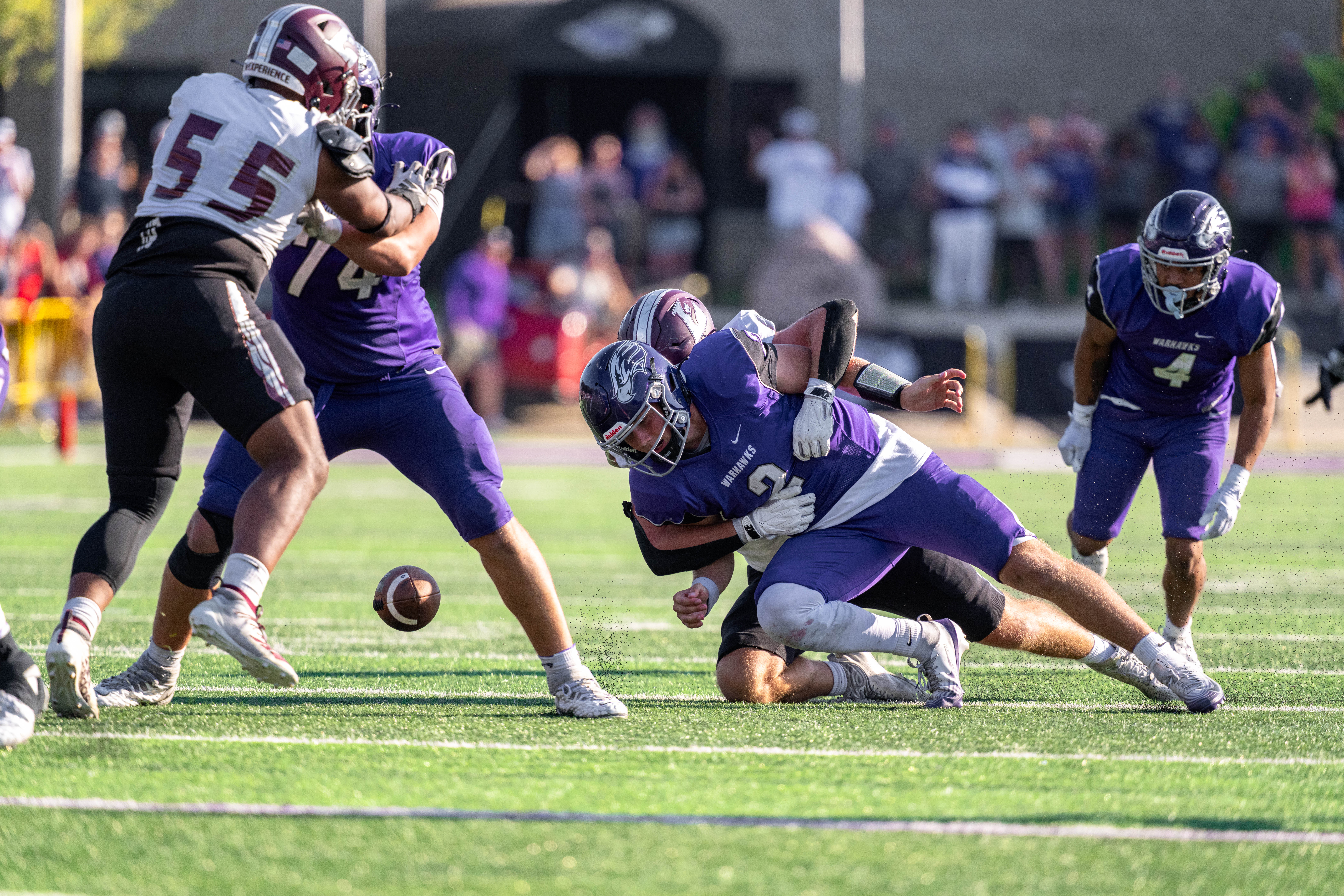 Oct 4, 2025; Whitewater, Wisconsin, USA; University of Wisconsin-La Crosse Eagles defensive lineman Ben Moore (55) sacks University of Wisconsin-Whitewater Warhawks quarterback Justin Klinkner (2) forcing a fumble durning a college football game between the University of Wisconsin-Whitewater Warhawks and the University of Wisconsin-La Crosse Eagles at Perkins Stadium on October 04, 2025 in Whitewater, Wisconsin. Photography by Ross Harried for Second Crop Sports.